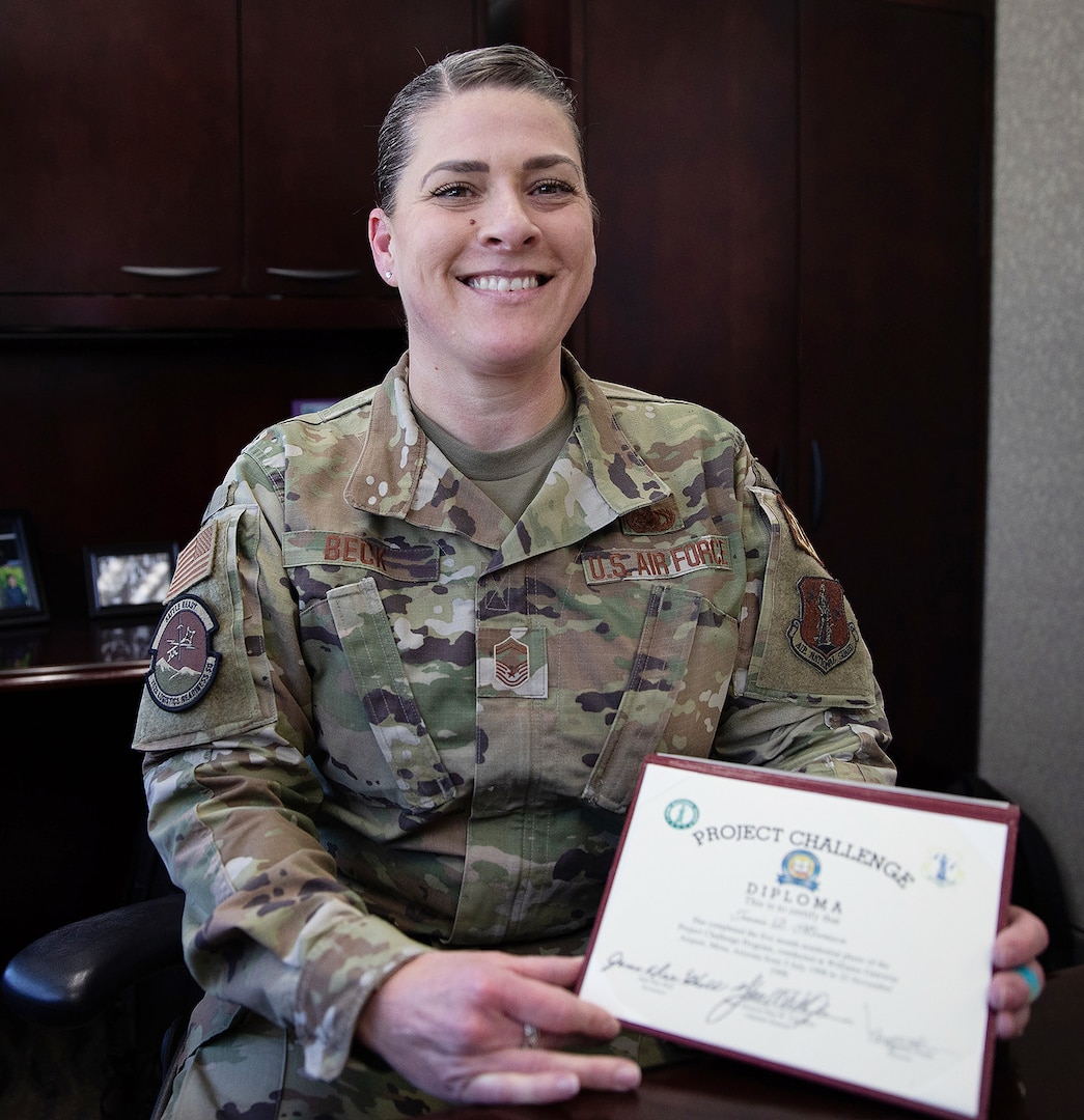 Senior Master Sgt. Jeanie Beck holds her diploma she recieved from the National Guard Youth ChalleNGe program. Beck, the chief enlisted manager for 152nd Logistics Readiness Squadron, is to be promoted to chief master sergeant June 25, 2022.