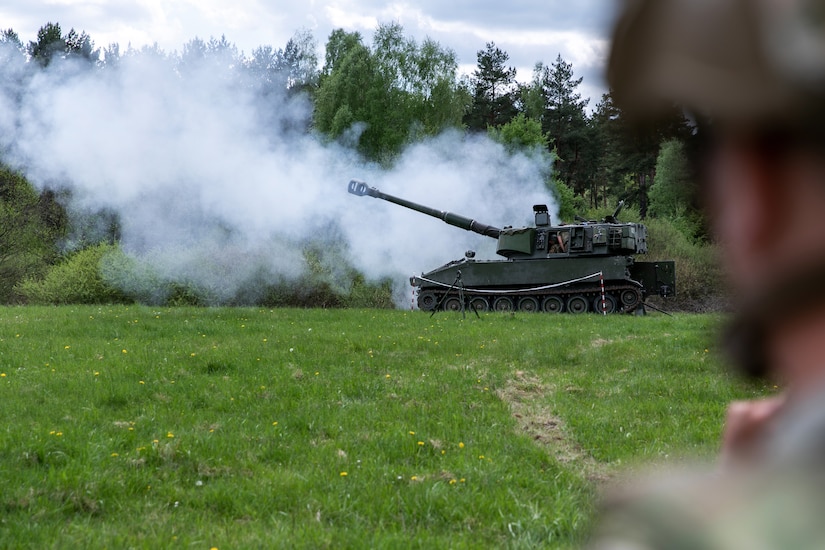 Smoke fills the area in front of a military tank that recently fired its artillery.