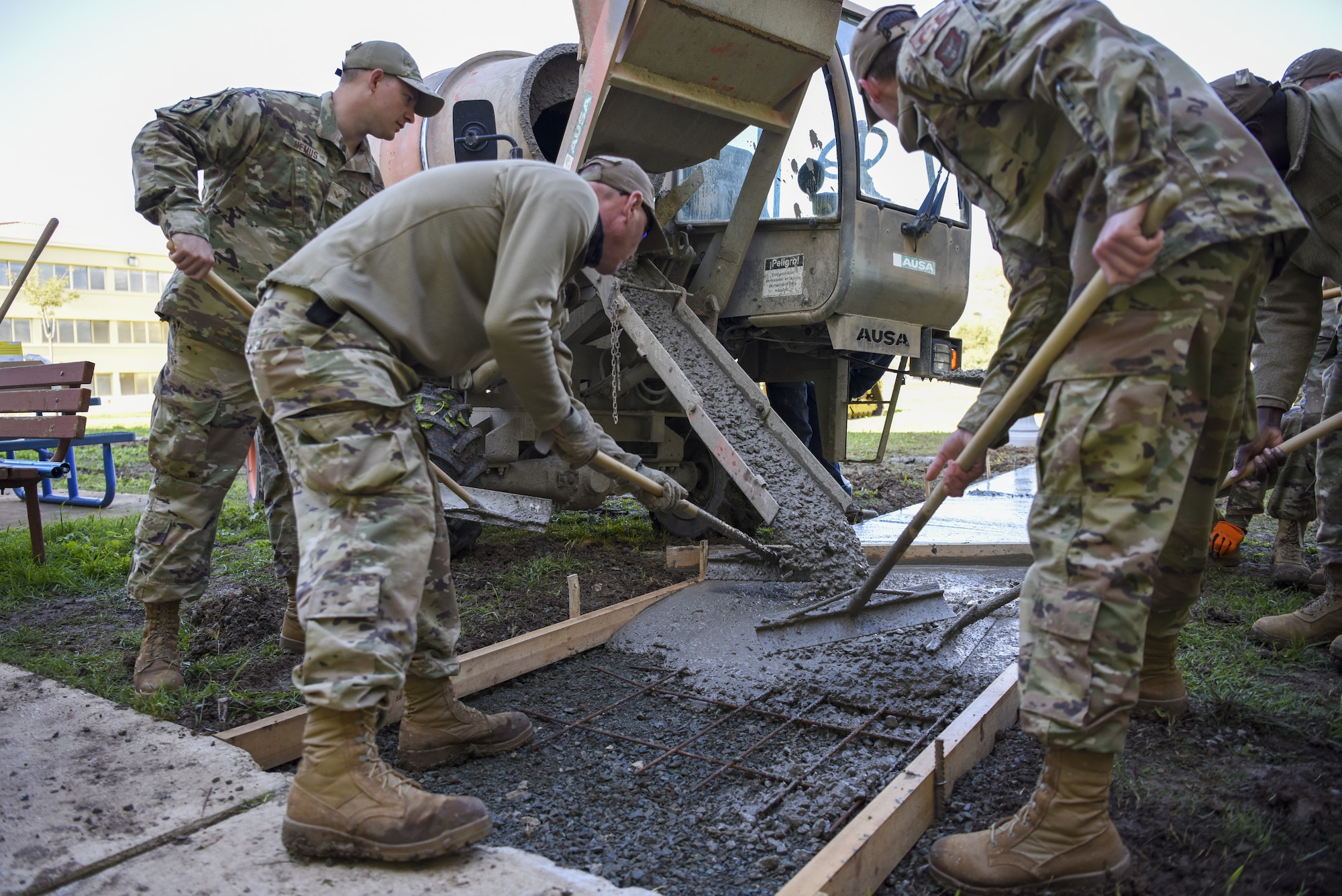 U.S. Air Force Airmen from the 911th Civil Engineer Squadron spread wet concrete that was poured to repair a sidewalk on Morón Air Base, Spain, April 1, 2022. Airmen from the 911 CES, out of Pittsburgh, Pa., spent their annual reserve tour at Morón AB where they aided the local CE shop on a few major projects.