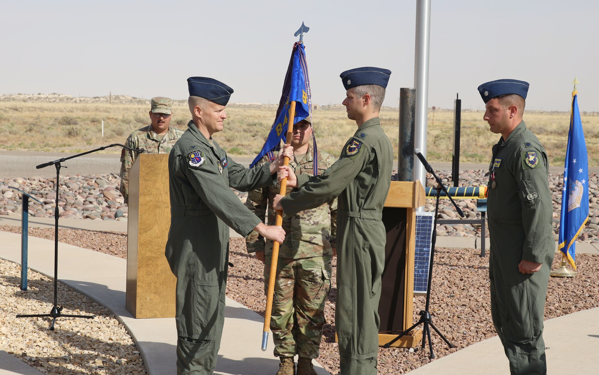 Lt. Col. Jared Rupp, second from right, accepts the guidon for the 846th Test Squadron from Col. Darren Wees, 704th Test Group commander, during a Change of Command ceremony June 9, 2022, at the Holloman High Speed Test Track on Holloman Air Force Base, N.M. Rupp assumed command of the 846 TS, the squadron that operates the HHSTT. The mission of the 846 TS is to plan and execute world-class rocket sled tests enabling weapon system development in support of the warfighter. The squadron is part of the 704th Test Group at Holloman, a unit of Arnold Engineering Development Complex, headquartered at Arnold Air Force Base, Tenn. (U.S. Air Force photo by Philip Cooksey)