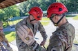 Sgt. 1st Class Chase Stevens, senior instructor with Company B, 399th Regiment (Cadet Summer Training), left, checks the rappel lines in the caribiner for Staff Sgt. Michael Soto, right, instructor with Co. B, 399th Regt. (CST) June 5 on the CST Rappel Tower on Fort Knox, Ky. Soldiers from 4th Battalion, 399th Regiment, will lead thousands of Reserve Officers' Training Corps cadets from across the country through the confidence/obstacle course and rappel tower at Fort Knox this summer starting in early June. (U.S. Army Reserve photo by Master Sgt. Ryan C. Matson)