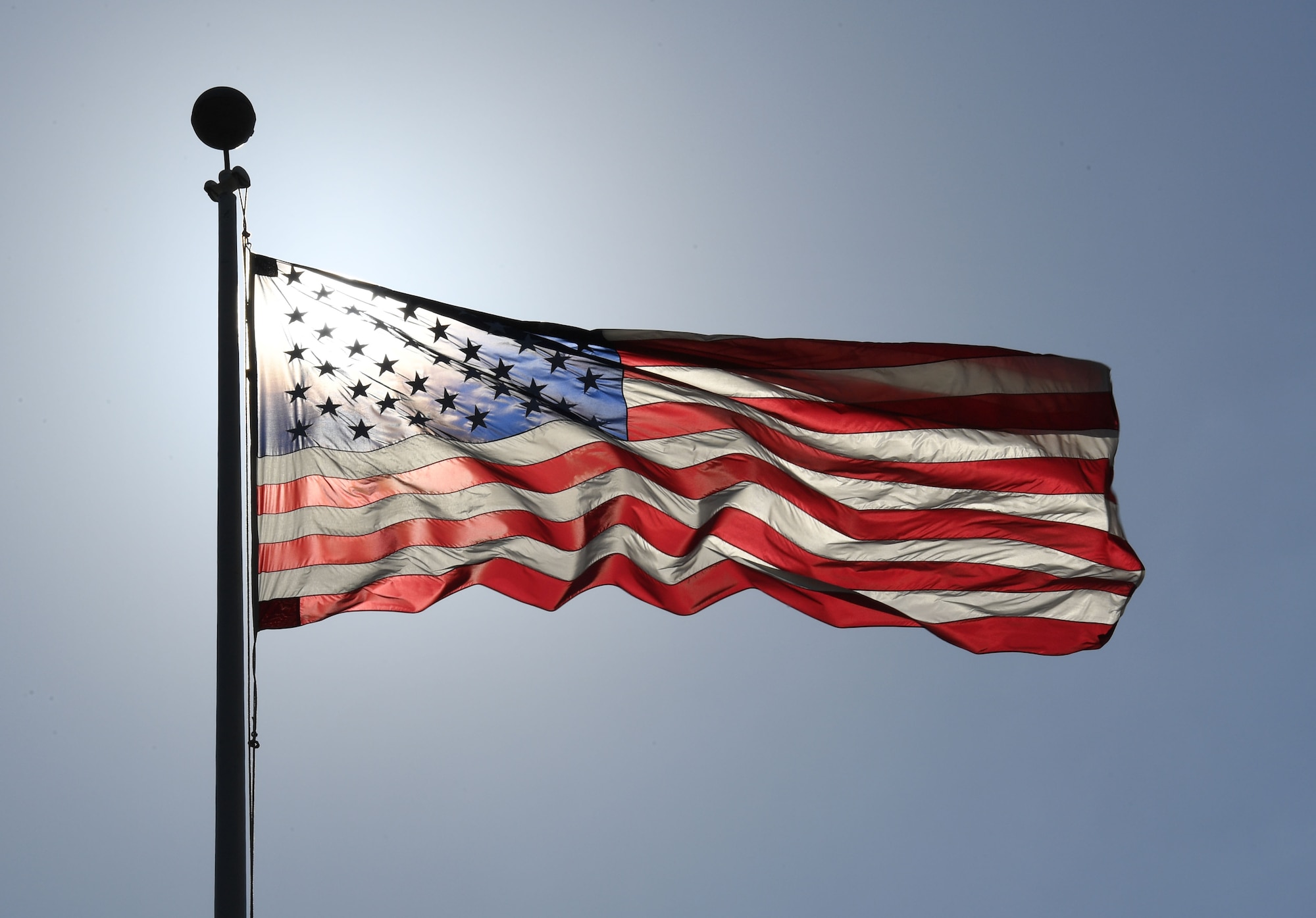 The U.S. flag is displayed during a retreat ceremony at Keesler Air Force Base, Mississippi, May 20, 2022. June 14 is Flag Day, a celebration of the history of the American flag and a time to remember proper etiquette for its display. Flag Day recognizes the adoption of the Stars and Stripes as the official flag of the United States on June 14, 1777, by the Continental Congress meeting in Philadelphia. This is the 5th year that the Air Force Sergeants Association Chapter 652 has volunteered to place 1,000 flags along Larcher Blvd. and Meadows Drive. (U.S. Air Force photo by Kemberly Groue)