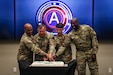 U.S. Army Central Celebrates Army's 247th Birthday With Ceremonial Cake-Cutting.

(Left to Right)  USARCENT Commanding General, LTG Ronald Clark, LTC Kenneth Boes, SPC Archie McParland, and CSM Carlos Evans cut the cake during a ceremony at Patton Hall.  The cake was cut using a replica M1913 Patton Sword, designed by then-2nd Lt. George Patton.