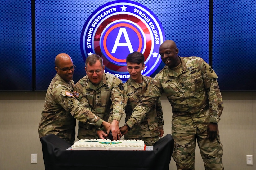 U.S. Army Central Celebrates Army's 247th Birthday With Ceremonial Cake-Cutting.

(Left to Right)  USARCENT Commanding General, LTG Ronald Clark, LTC Kenneth Boes, SPC Archie McParland, and CSM Carlos Evans cut the cake during a ceremony at Patton Hall.  The cake was cut using a replica M1913 Patton Sword, designed by then-2nd Lt. George Patton.