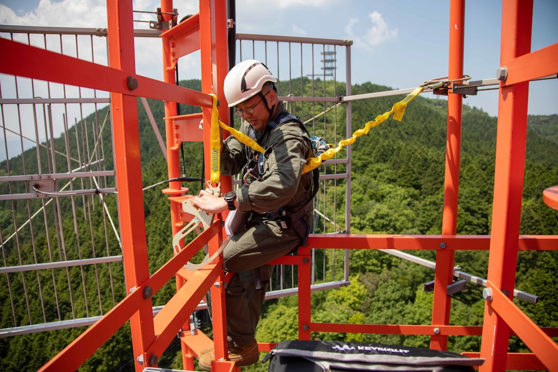 U.S. Marine Corps Lance Cpl. Xinxin Dai, an air traffic control communications technician, attaches a harness to a radio tower in Yamaguchi Prefecture, Japan, May 17, 2022. Marine Corps Air Station Iwakuni’s radio towers are maintained weekly because of their vital role in the communication and safety between several units at the air station. Due to the geographic scope of the Indo-Pacific Command area of responsibility MCAS Iwakuni serves as a vital link between multiple countries in the Western Pacific theater.