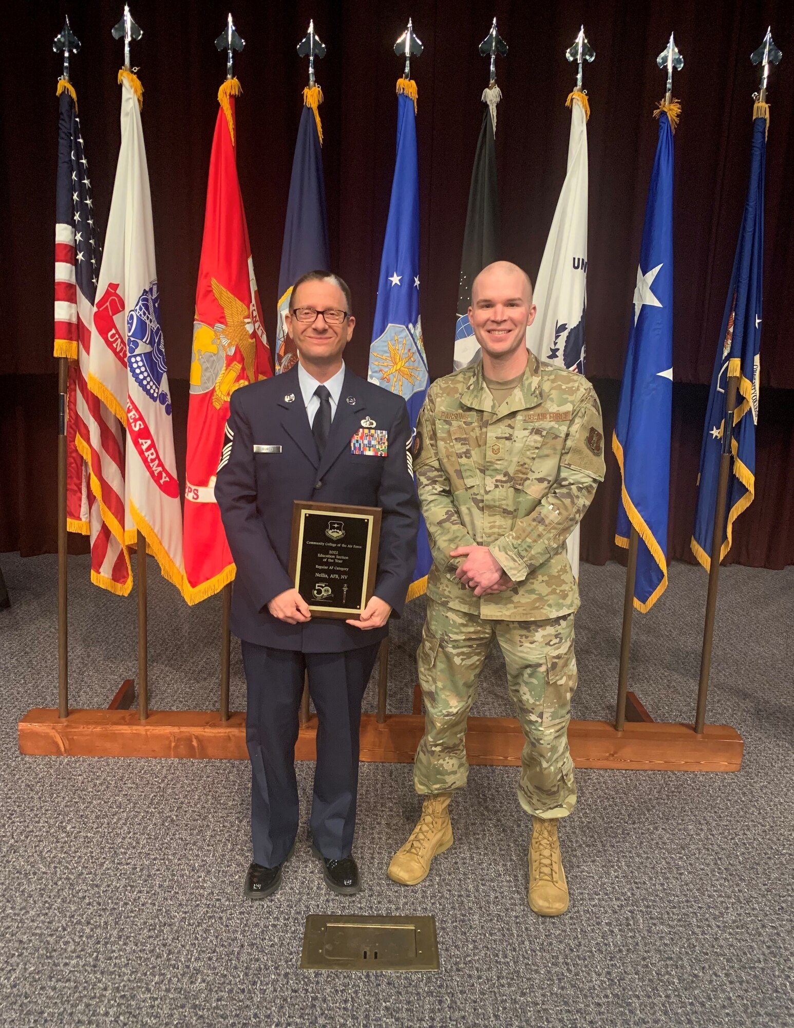 132d Wing Members, Senior Master Sgt. Gary Burch and Master Sgt. Jacob Parsons pose for a photo with their newly received award