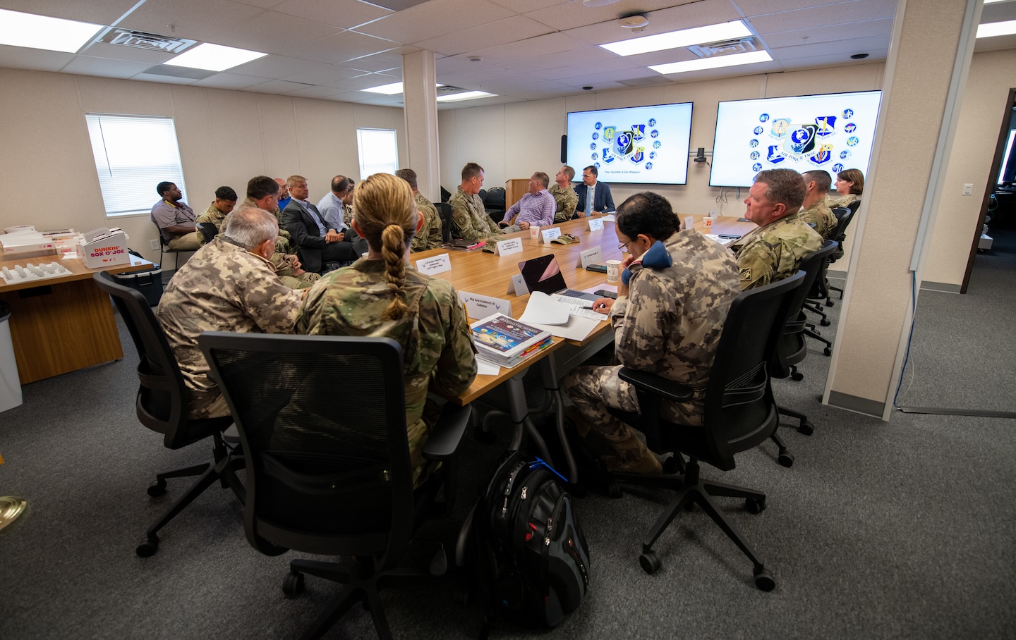 Members of the Qatar Emiri Corps of Engineers, U.S. Army, U.S. Air Force and Tyndall Air Force Base rebuild partners discuss logistics during a tour at Tyndall Air Force Base, Florida, June 9, 2022. The briefings contained valuable information to help members better understand the complex rebuilding process. (U.S. Air Force photo by Airman 1st Class Zachary Nordheim)