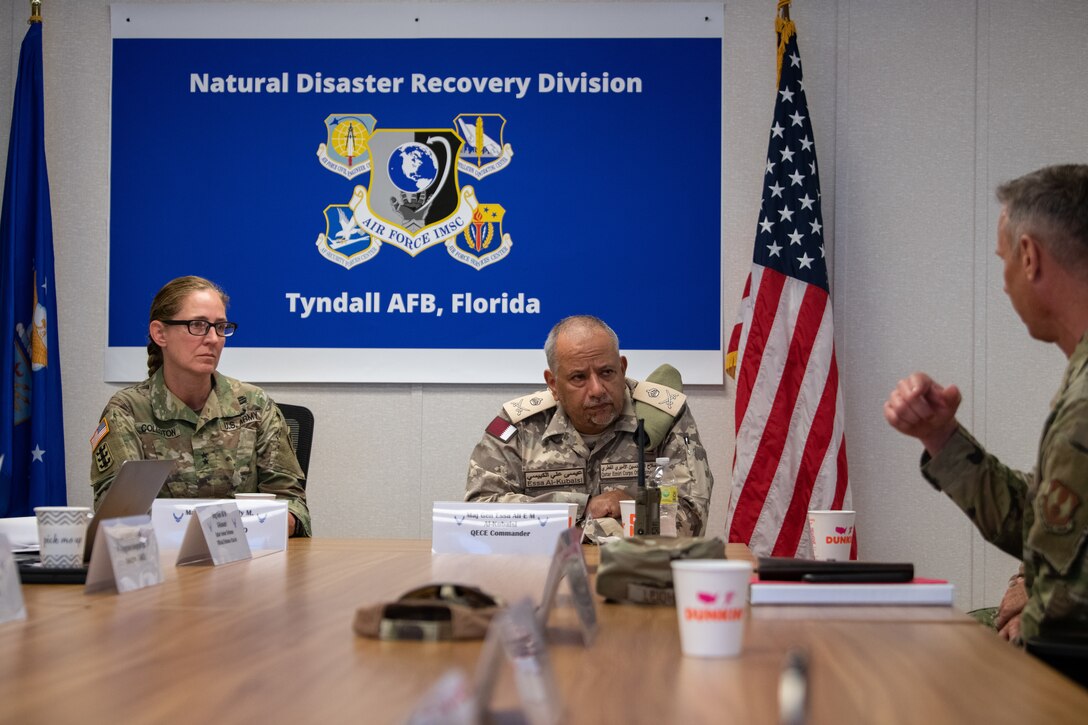 U.S. Army Maj. Gen. Kimberly M. Colloton, Transatlantic Expeditionary District commander, left, and Qatar Emiri Corps of Engineers Maj. Gen. Essa Ali E M Al-Kubaisi, QECE commander, center, discuss Tyndall Air Force Base logistics with U.S. Air Force Col. Travis Leighton, director of the Air Force Civil Engineer Center Natural Disaster Recovery Division, during a tour at Tyndall Air Force Base, Florida, June 9, 2022. The members discussed Tyndall’s rebuild process in contrast to normal base operations. (U.S. Air Force photo by Airman 1st Class Zachary Nordheim)