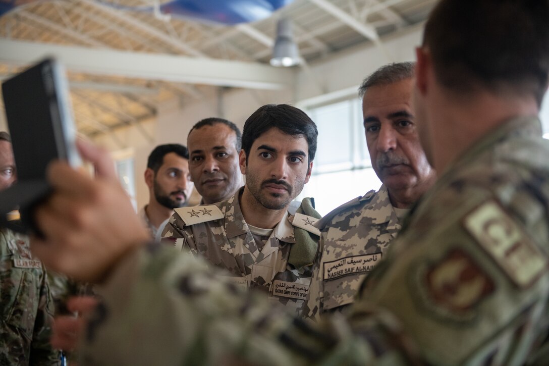 Members of the Qatar Emiri Corps of Engineers watch U.S. Air Force 2nd Lt. Nicholas Cap, Air Force Civil Engineer Center project manager/engineer, right, demonstrate digital twin capabilities in the fitness center at Tyndall Air Force Base, Florida, June 9, 2022. The implementation of this technology supports maintenance and project management. (U.S. Air Force photo by Airman 1st Class Zachary Nordheim)