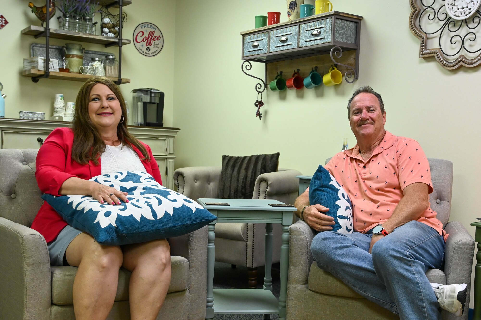 From left, Susan Bradford, 97th Air Mobility Wing (AMW) violence prevention integrator (VPI), and Chris Hargis, 97th AMW community support coordinator (CSC), sit in the VPI coffee lounge at the Airmen Readiness Center at Altus Air Force Base (AAFB), Oklahoma, June 9, 2022. The VPI and CSC work hand-in-hand to provide a better quality of life for Airmen and their families at AAFB. (U.S. Air Force photo by Senior Airman Kayla Christenson)