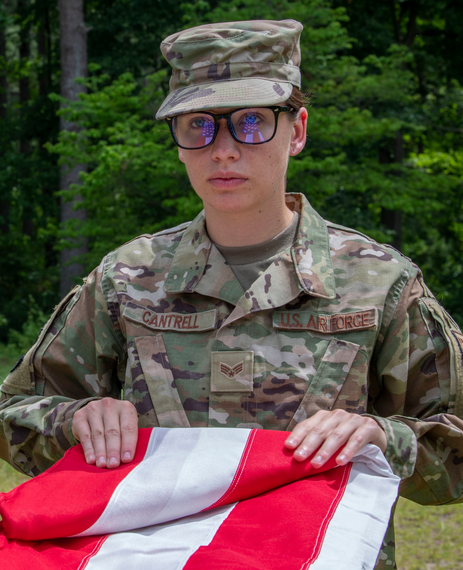 Senior Airman Hannah Cantrell, 333rd Fighter Generation Squadron aerospace propulsion journeyman, folds the American Flag in a practice flag folding ceremony at Seymour Johnson Air Force Base, North Carolina, June 14, 2022. Along with aerospace propulsion duties, Cantrell is also a member of the base honor guard. The honor guard responsibilities are to receive or guard a head of state or other dignitaries, the fallen in war, or to attend state ceremonials or funerals. (U.S. Air Force photo by Airman 1st Class Sabrina Fuller)