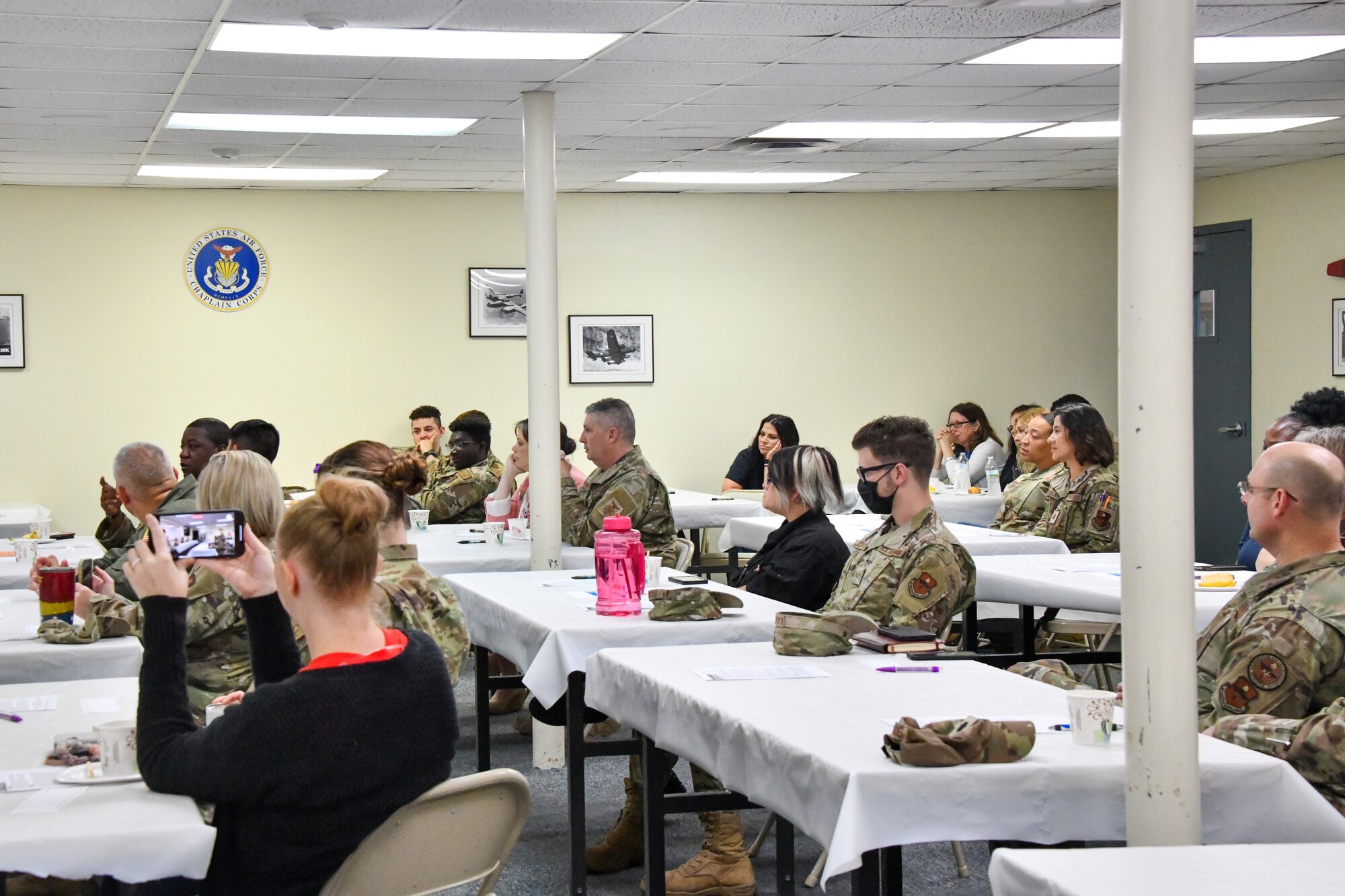 Airmen from the 97th Air Mobility Wing listen to an LGBTQ+ discussion panel at Altus Air Force Base, Oklahoma, June 10, 2022. More than 30 Airmen attended the event. (U.S. Air Force photo by Airman 1st Class Miyah Gray)