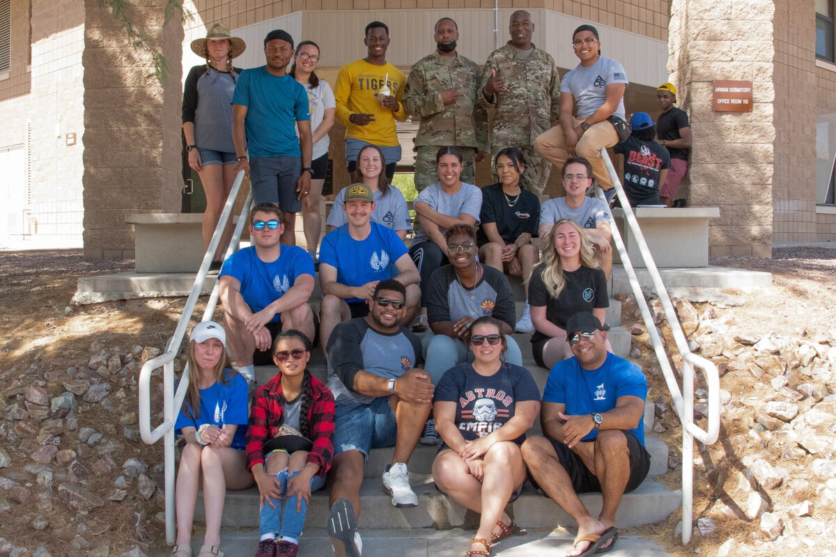 A group photo of Airmen sitting on steps.
