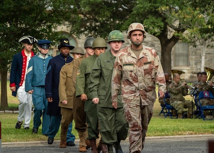 U.S. Army Soldiers dressed in past Army military uniforms walk to the front for a demonstration during the Army’s 247th birthday celebration, held at Joint Base San Antonio-Fort Sam Houston, Texas, June 14, 2022. The Army’s annual birthday celebration highlights total force history and tradition, and commemorates the continuous commitment to defending America 24/7. (U.S. Army Photo by Spc. Andrea Kent)