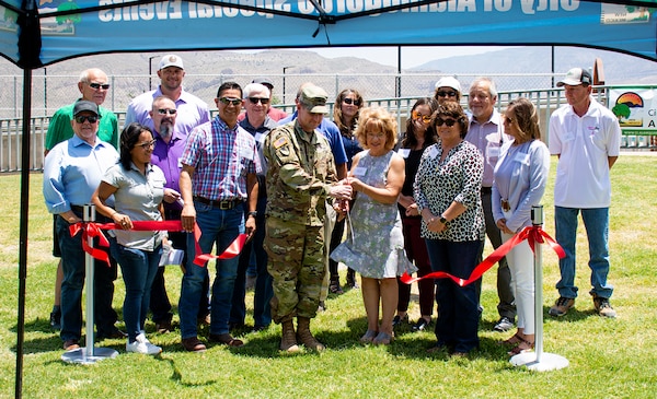 ALAMOGORDO, N.M. – As Lt. Col. Patrick Stevens and Alamogordo Mayor Susan Payne cut the ribbon to officially mark the completion of Phase 8 of the McKinley Channel Flood Control Project, June 8, 2022, USACE-Albuquerque District project manager Brian Sanchez, (immediate left of Stevens), and Alamogordo Director of Public Works Nancy Beshaler, (immediate right of Payne), join with other city, congressional and USACE representatives to look on.