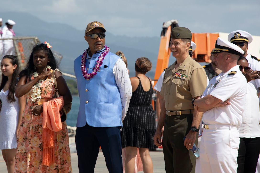 U.S. Marine Corps Maj. Gen. Mark Hashimoto, middle right, executive director, U.S. Marine Corps Forces, Pacific, talks with Mr. Frank Petersen III, middle left, during a homecoming ceremony for the Arleigh Burke-class guided-missile destroyer USS Frank E. Petersen, Jr. (DDG 121) at Joint Base Pearl Harbor-Hickam, Hawaii, June 13, 2022. The USS Frank E. Petersen, Jr. is named after retired U.S. Marine Corps Lt. Gen. Frank E. Petersen, Jr. who was the first Black U.S. Marine Corps aviator and the first Black Marine to become a three-star general. Petersen served two combat tours, in Korea in 1953 and in Vietnam in 1968. He flew more than 350 combat missions and had more than 4,000 hours in various fighter and attack aircraft. (U.S. Marine Corps photo by Cpl. Sasha Pierre-Louis)