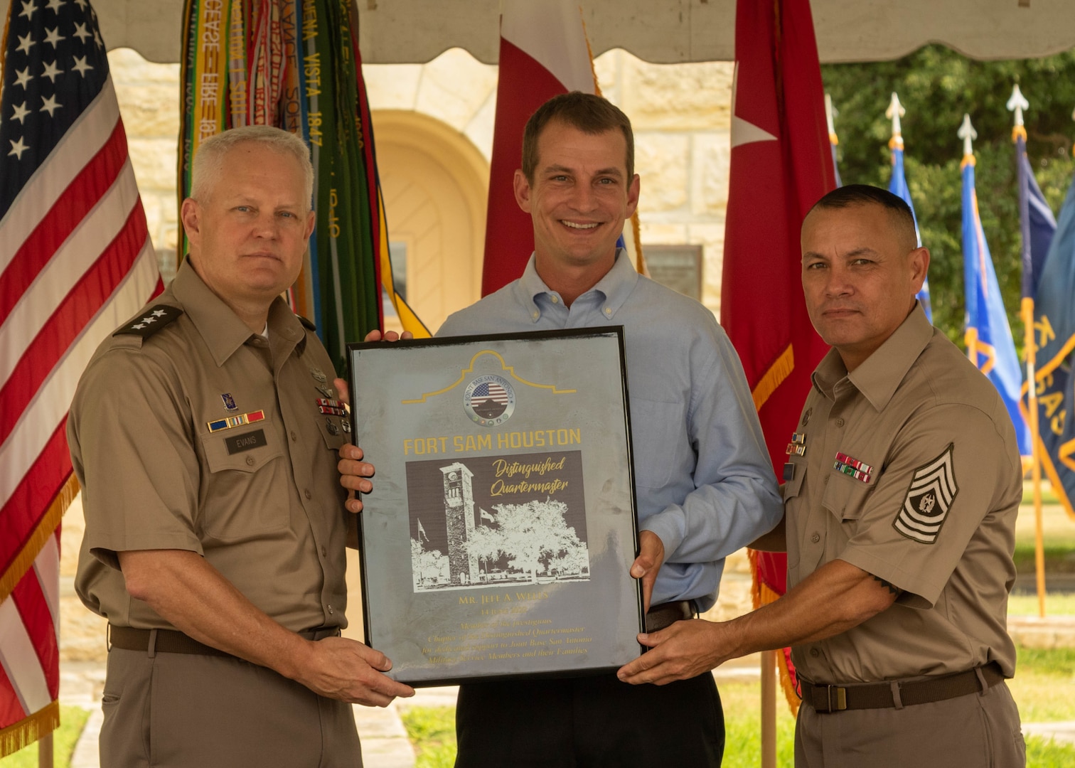 U.S. Army Lt. Gen. John R. Evans, commanding general of Army North, and Command Sgt. Maj. Phil K. Barretto, senior enlisted advisor of Army North, presents Jeff Wells with a plaque  inducting him into the Distinguished Quartermasters during the Army’s 247th birthday celebration, held at Joint Base San Antonio-Fort Sam Houston, Texas, June 14, 2022. Distinguished Quartermasters greatly reflect exceptional contribution to the Army mission through their tireless support to military programs and the San Antonio community. The Army’s annual birthday celebration highlights total force history and tradition, and commemorates the continuous commitment to defending America 24/7. (U.S. Army Photo by Spc. Andrea Kent)