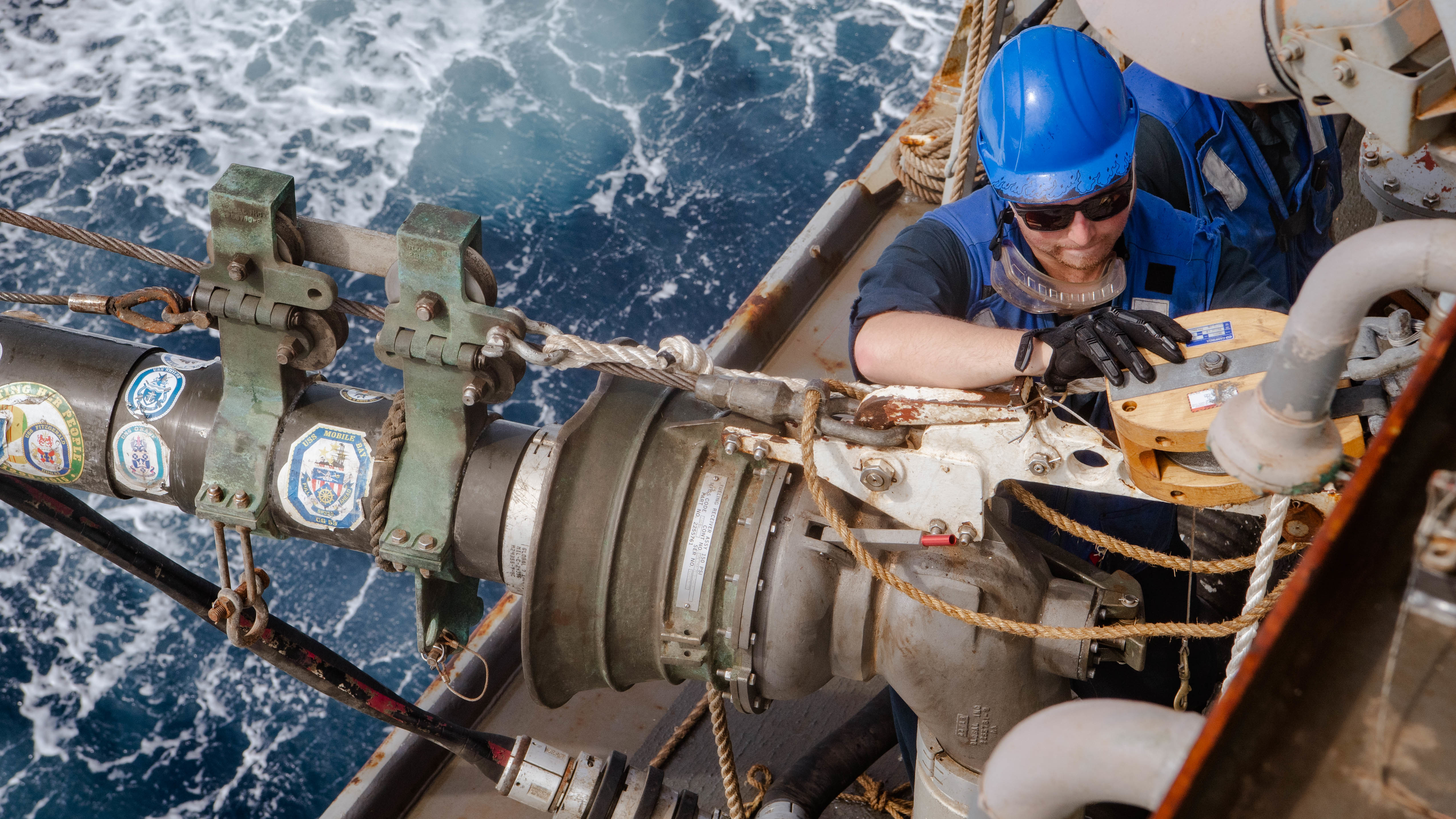 Boatswain's Mate 3rd Class Erik Just works on the fuel pump during a replenishment-at-sea with the Military Sealift Command dry cargo and ammunition ship USNS Charles Drew (T-AKE 10) aboard the guided-missile destroyer USS Momsen (DDG 92) in the Arabian Sea.