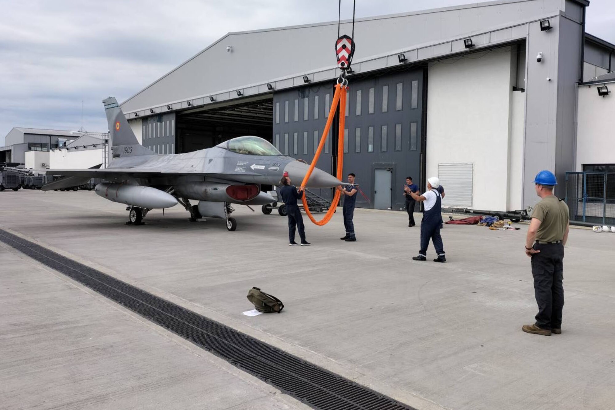 U.S. Airmen from the 31st Maintenance Group and maintainers from the Romanian air force train on how to attach a sling and belly band