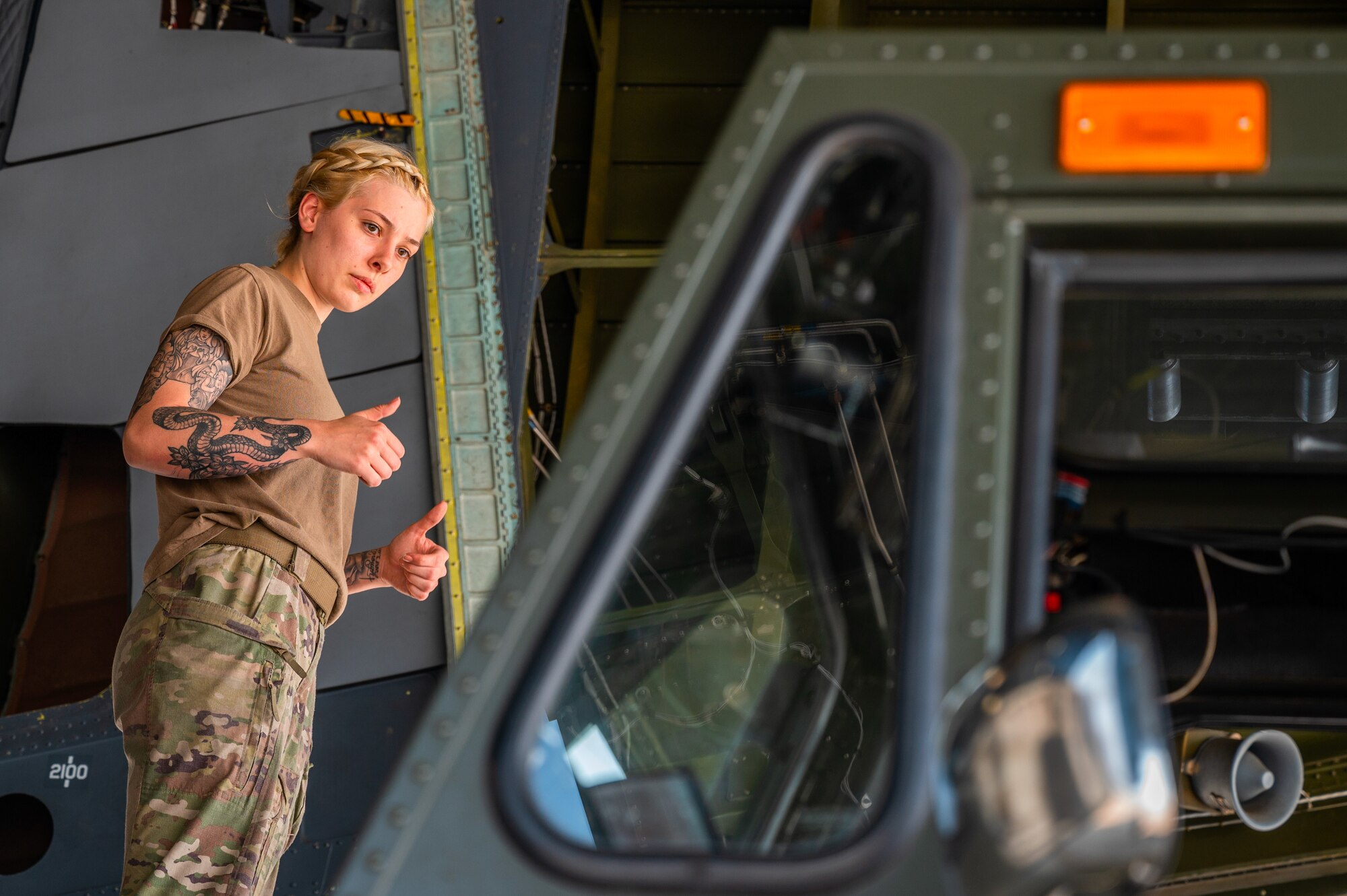 Airman 1st Class Gabriella Cunningham directs the K-loader operator from atop a C-5M Super Galaxy
