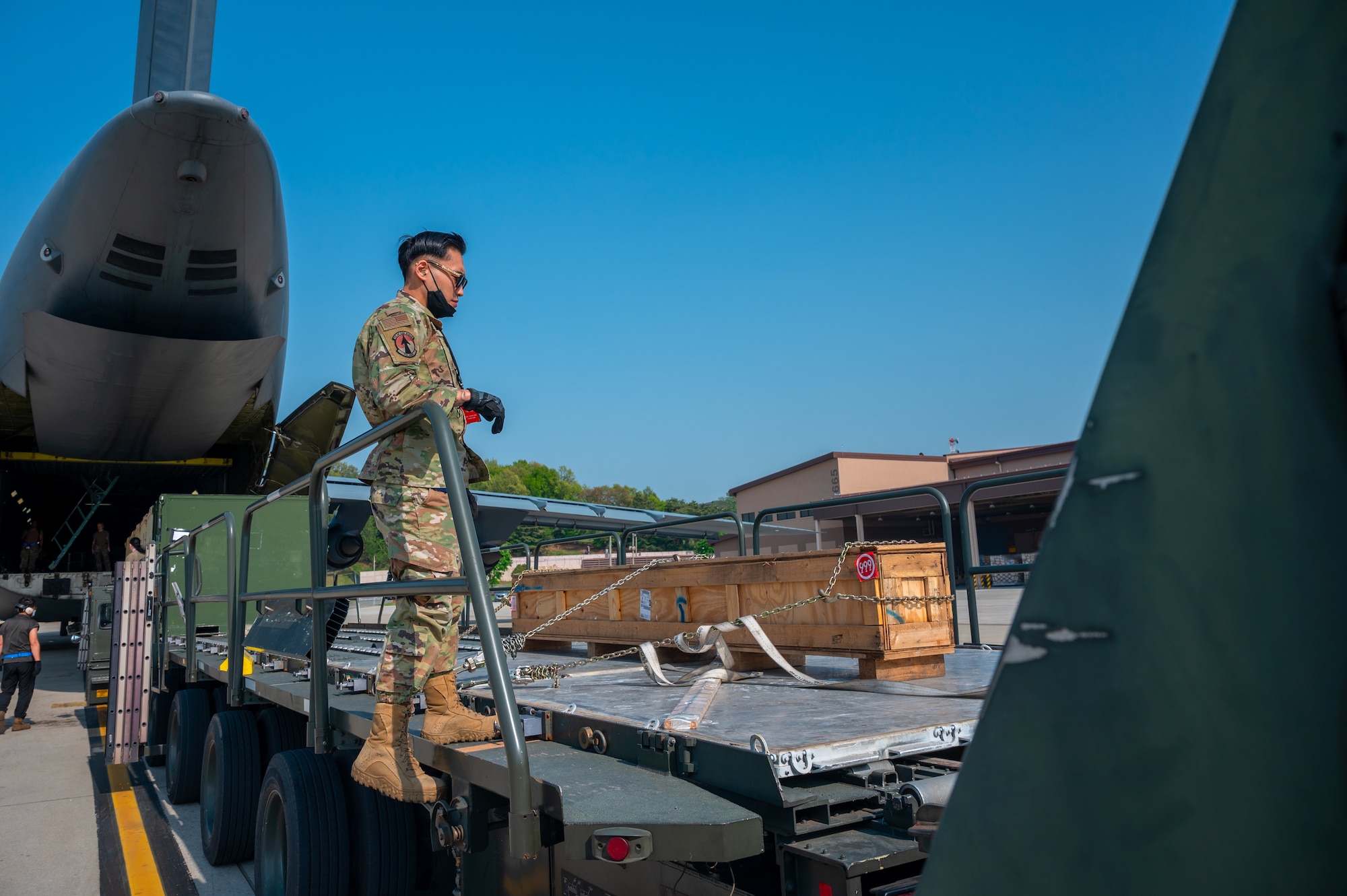 1st Lt. Kenneth Elejorde supervises the unloading and offloading of pallets