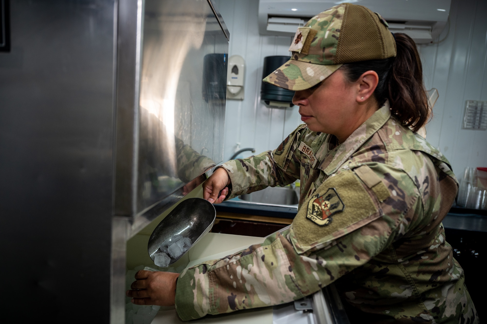 Maj. Allison Bradford, Expeditionary Medical Group preventative and aerospace medicine flight commander, takes a sample of ice cubes to test for acceptable ranges in pH, chlorine, and bacteriological presence at an undisclosed location in Southwest Asia, May 11, 2022. Members from the bioenvironmental engineering and public health teams work together in a deployed location to form the Preventive and Aerospace Medicine team. (U.S. Air Force photo by Master Sgt. Christopher Parr)