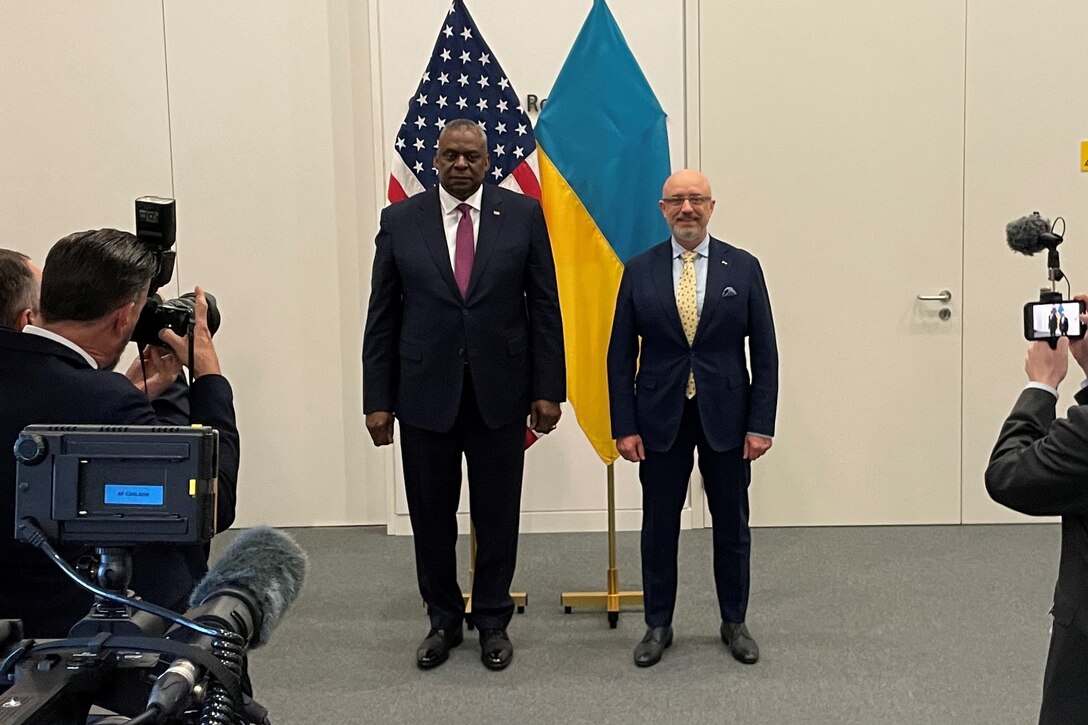Two men pose for pictures.