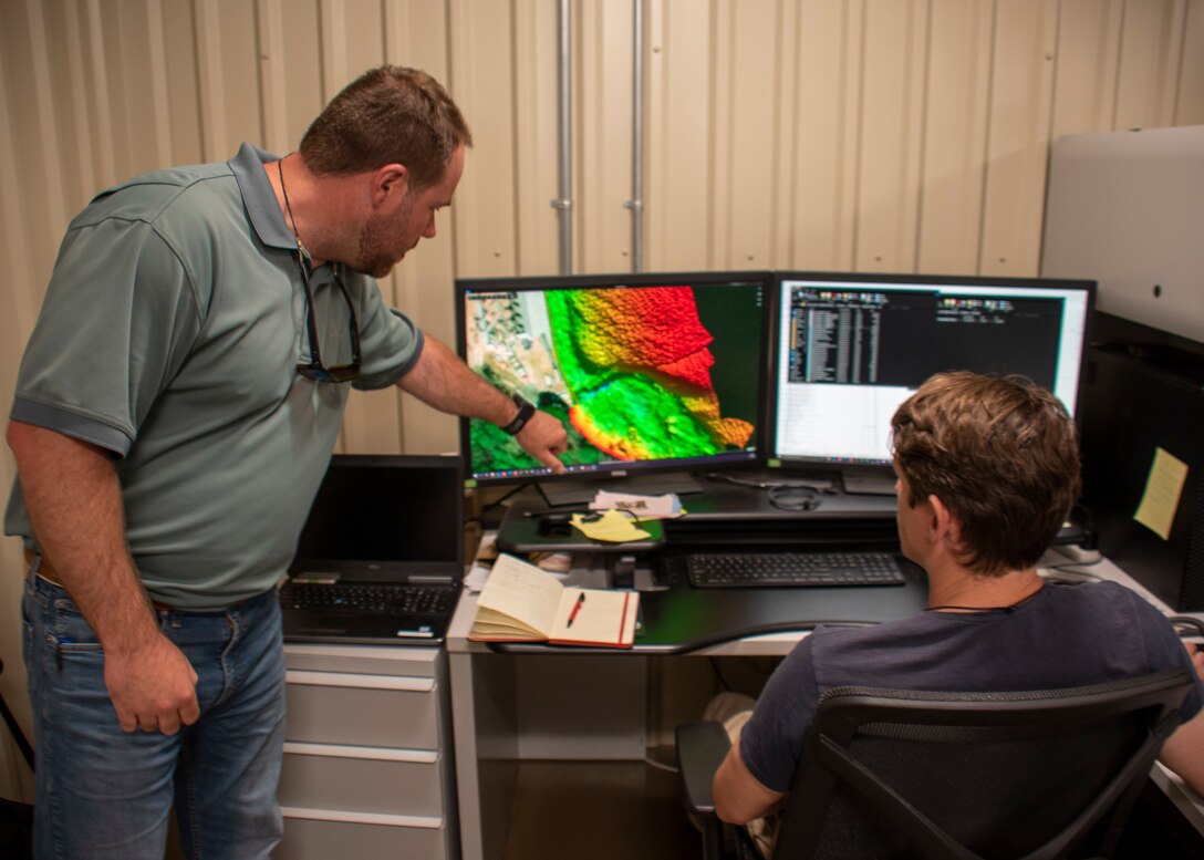 Chris Wheeler, Savannah District hydro-survey section chief, left, and Miles Saunders, hydro-survey geographer, review a rendering of the Savannah River bottom created by data points received from multi-beam sonar survey.
