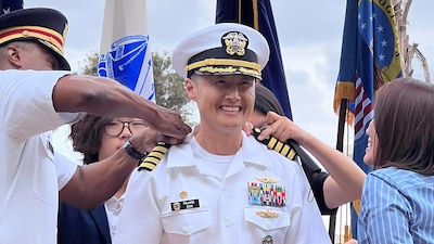 a military officer puts on new shoulder boards