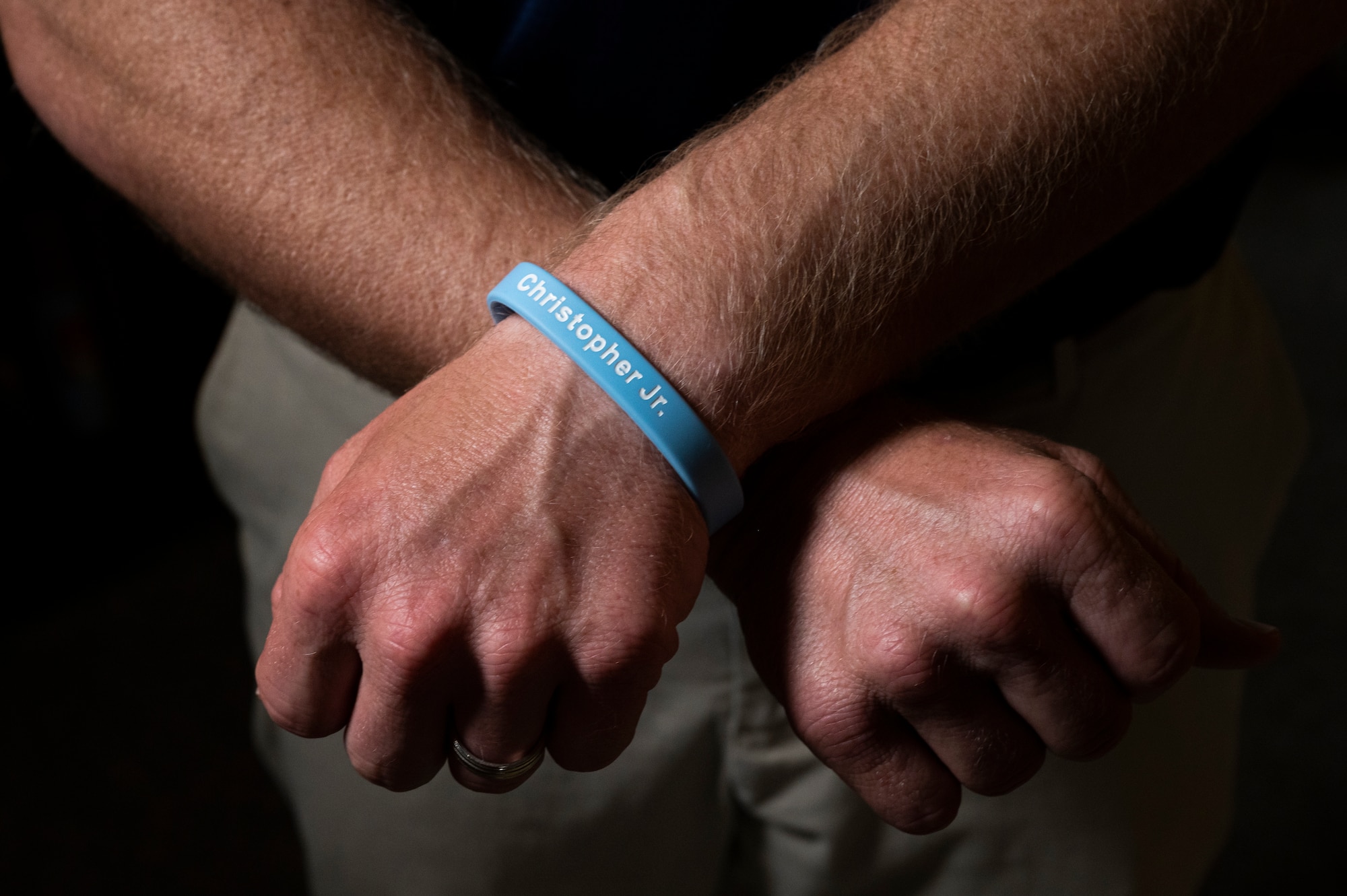 Christopher Schlachter Sr., wears a bracelet in memory of his son, Christopher Schlachter Jr., in O'Fallon, Illinois, June 10, 2022. In order to carry on his name, Schlachter Sr. started the Christopher Jr. Legacy for Drowning Prevention program in 2016 in partnership with the YMCA in O’Fallon and since its inception, the program have provided swimming lessons and educated over a thousand families on proper water safety and prevention. (U.S. Air Force photo by Staff Sgt. Dalton Williams)