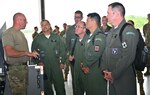 New York Air National Guard Master Sgt. Eric Wintersteen, a crew chief assigned to the 174th  Attack Wing's Maintenance Group, explains the airframe and engine inspection he is performing on a remotely piloted MQ-9 Reaper aircraft to   Brazilian Air Force officers visiting Hancock Field Air National Guard Base in Syracuse, New York, June 6, 2022. The stop was part of a week-long tour of New York Air National Guard facilities by Brazilian officers and NCOs as part of the State Partnership Program.