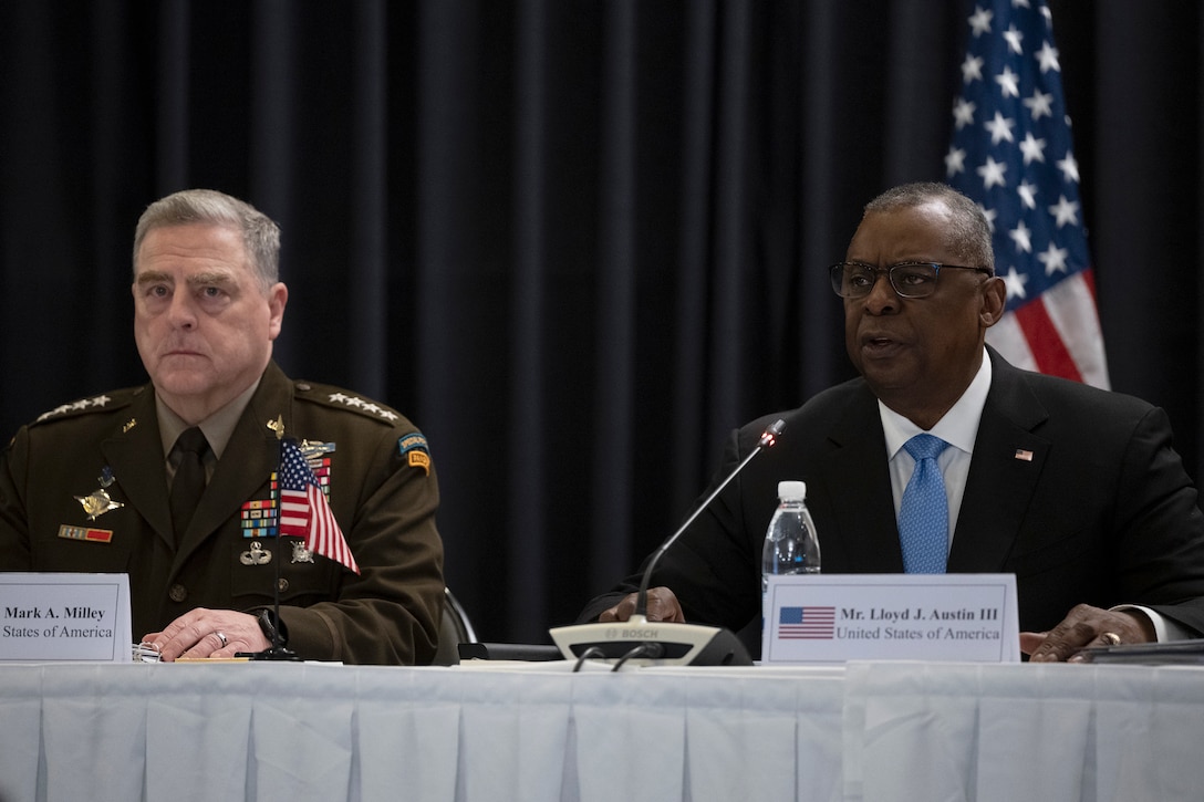 Army Gen. Mark A. Milley and Secretary of Defense Lloyd J. Austin III sit at a table.