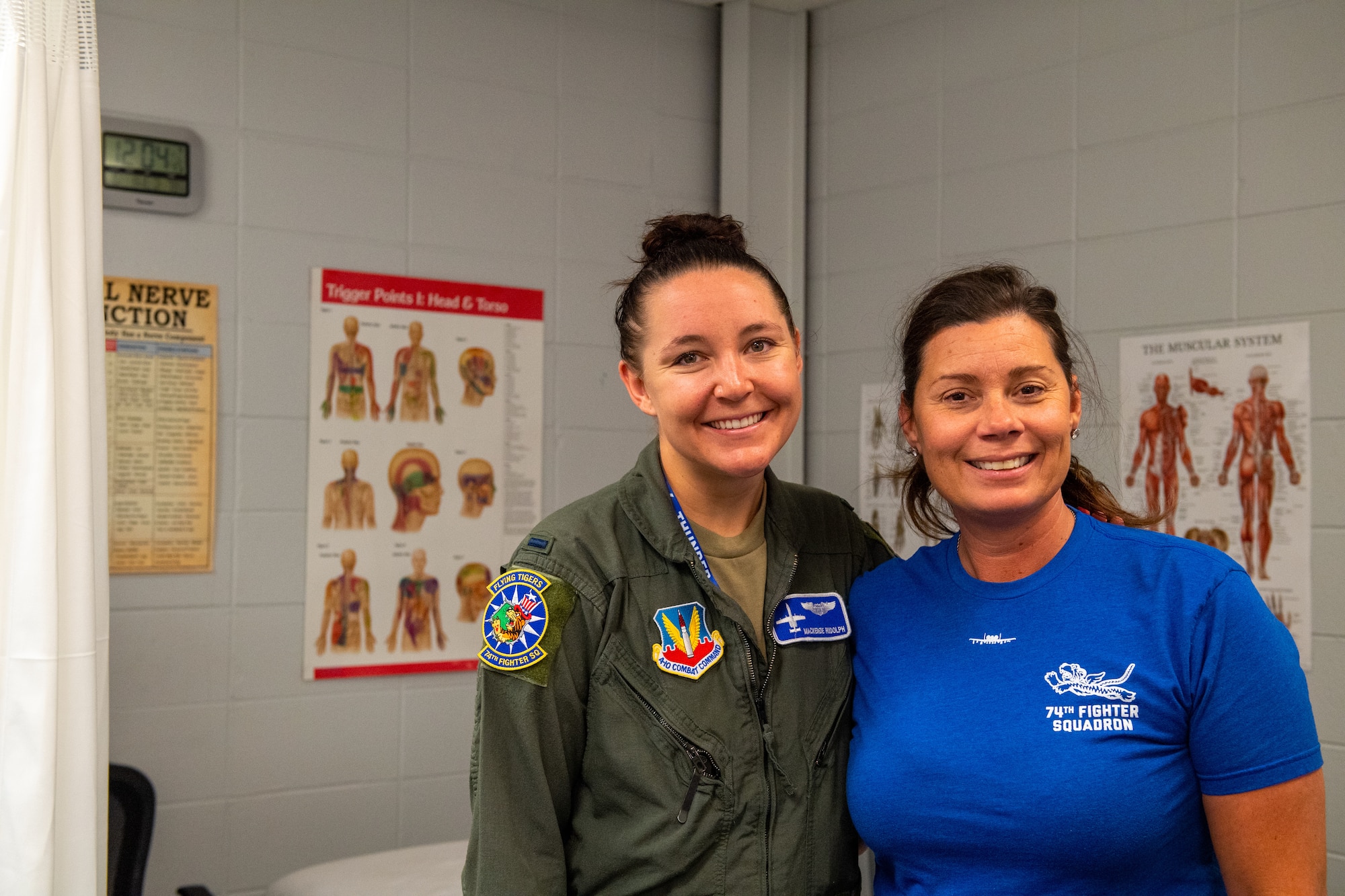 U.S. Air Force 1st Lt. Mackenzie Rudolph, 74th Fighter Squadron A-10 Thunderbolt II pilot (left), poses for a photograph with Robi Boney, 23rd Fighter Group Aircrew Performance Center licensed massage therapist, after a pre-flight stretching session at Moody Air Force Base, Georgia, June 1, 2022. The 23rd FG Pilots participate in the Optimizing the Human Weapons System Program in an effort to prevent potential injuries associated with flight. (U.S. Air Force photo by Airman 1st Class Courtney Sebastianelli)
