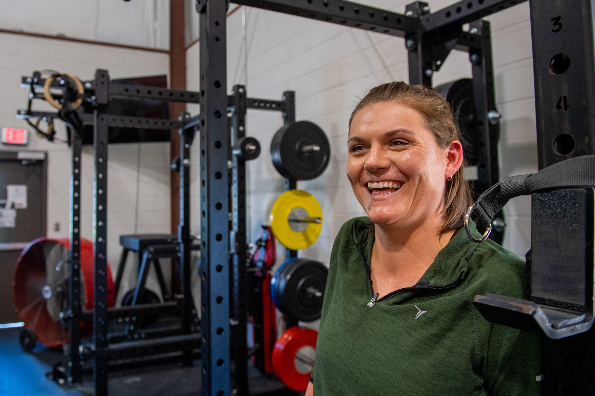 McKenna Bachmann, 23rd Fighter Group Aircrew Performance Center certified athletic trainer, poses for a photograph in the APC gym at Moody Air Force Base, Georgia, June 1, 2022. Bachmann provides pilots preflight exercises and stretching plans to maintain their range of motion. The Optimizing the Human Weapons System Program was implemented at Moody with the goal of preventing potential injuries associated with flight. (U.S. Air Force photo by Airman 1st Class Courtney Sebastianelli)