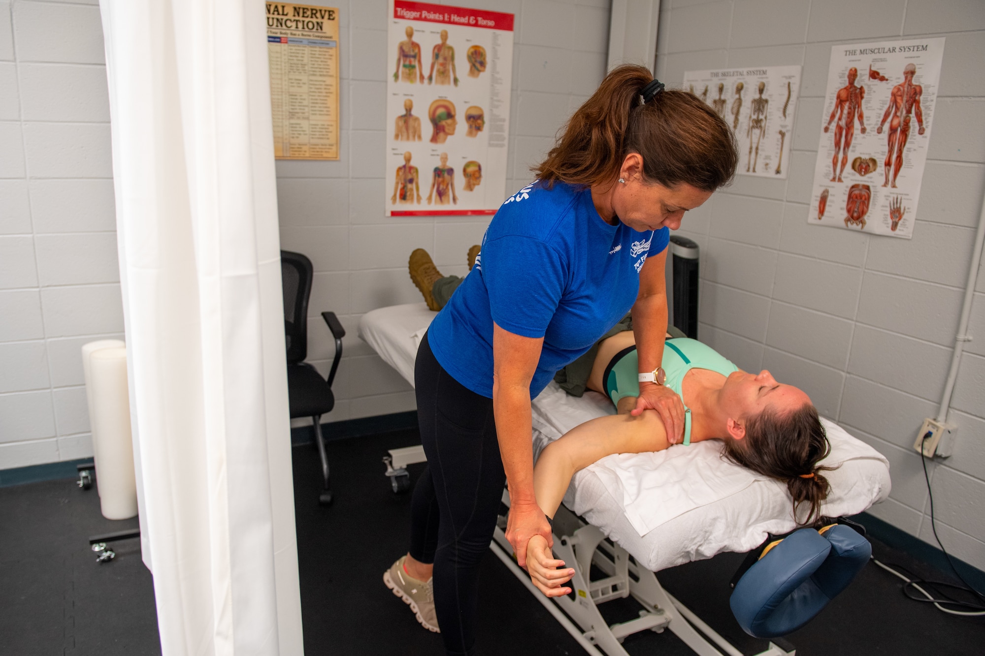 Robi Boney, 23rd Fighter Group Aircrew Performance Center licensed massage therapist, stretches out U.S. Air Force 1st Lt. Mackenzie Rudolph, 74th Fighter Squadron A-10 Thunderbolt II pilot, before a flight at Moody Air Force Base, Georgia, June 1, 2022. Neck and spinal injuries are just a few of the common challenges fighter pilots face. In an effort to reduce an array of injuries, the Optimizing the Human Weapons System Program team encourages the pilots to come in and stretch before flights. (U.S. Air Force photo by Airman 1st Class Courtney Sebastianelli)