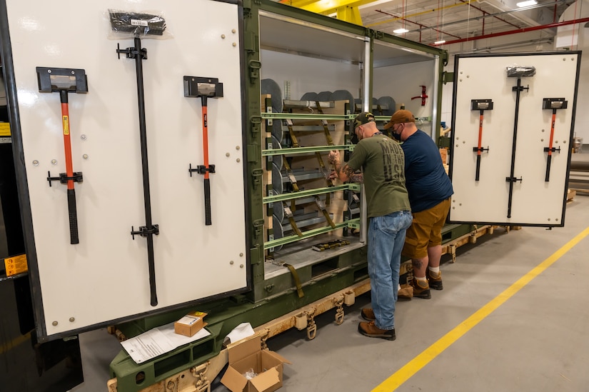 Photo of depot employees populating BSS kits.