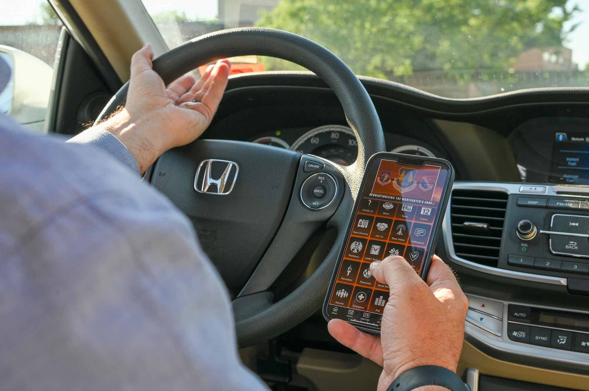 driver holds cell phone