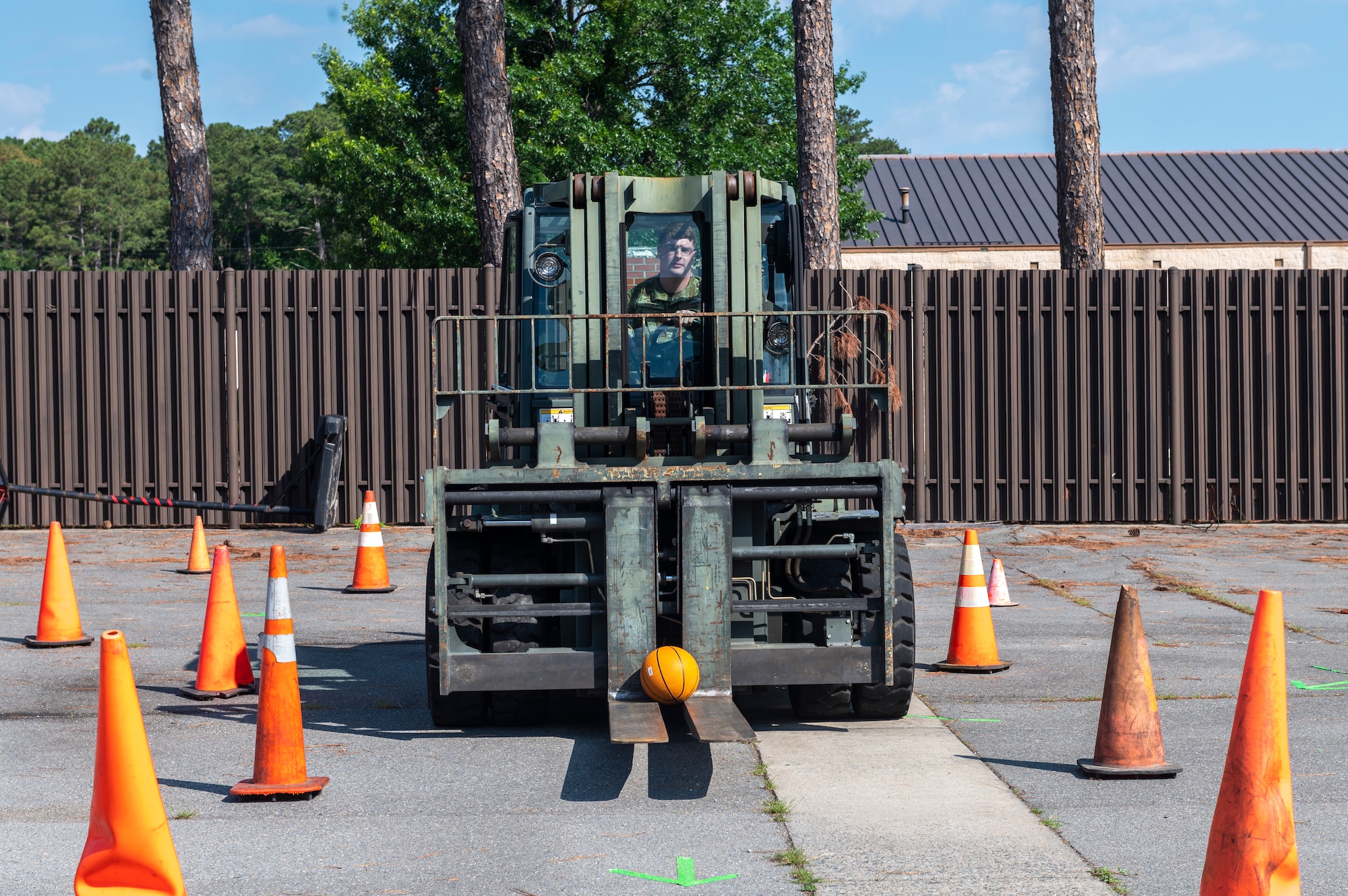The forklift obstacle course tested the participants abilities to successfully maneuver through a series of cones quickly and safely while transporting a basketball. (U.S. Air Force photo by Senior Airman Kylie Barrow)