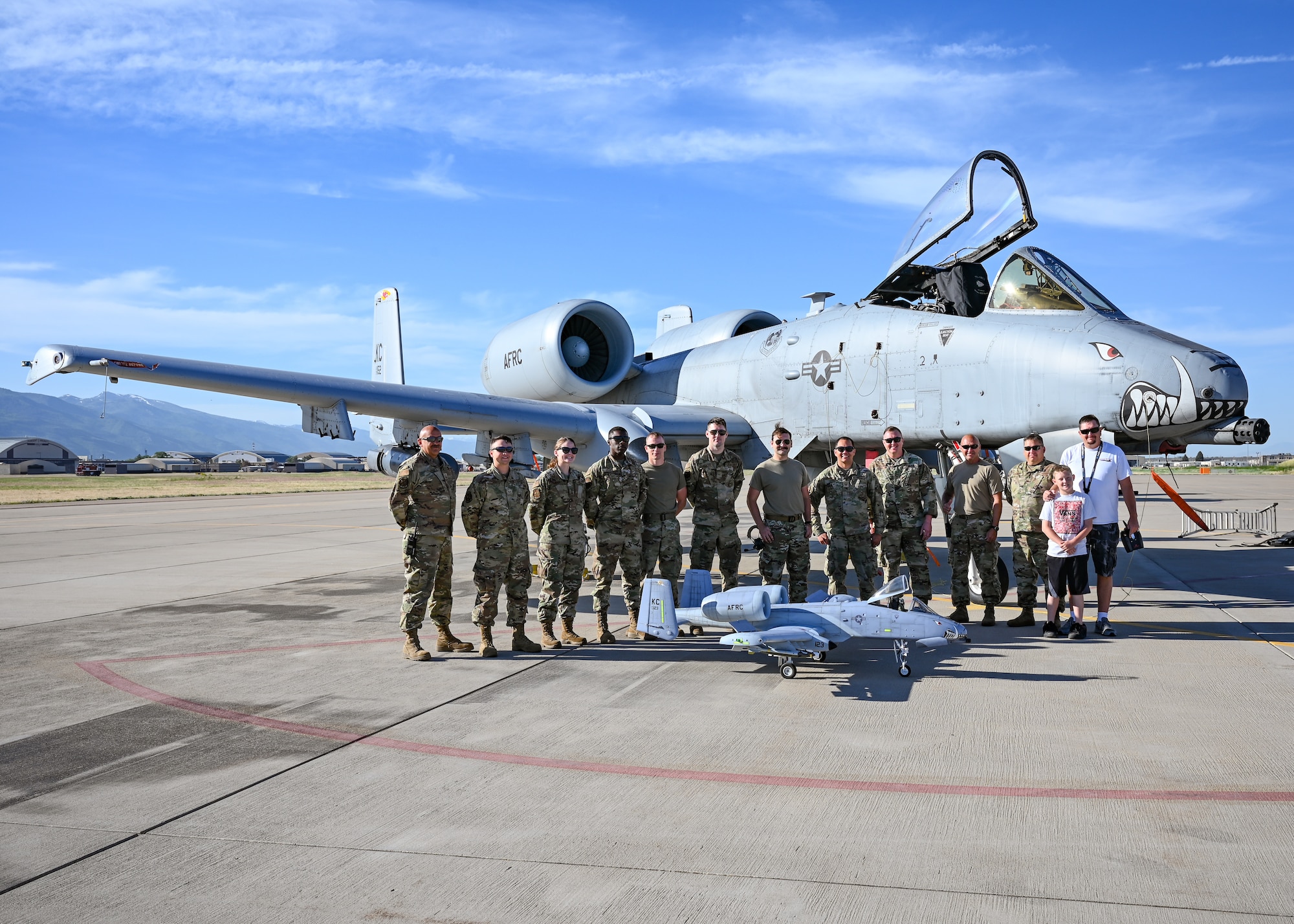 Members of the 442d Fighter Wing are photographed with a remote controlled A-10 Thunderbolt II and its owner at Hill Air Force Base, Utah, June 10, 2022. The RC plane has made appearances at air shows and RC events in Utah, California and Arizona. (U.S. Air Force photo by Tech. Sgt. Missy Sterling)