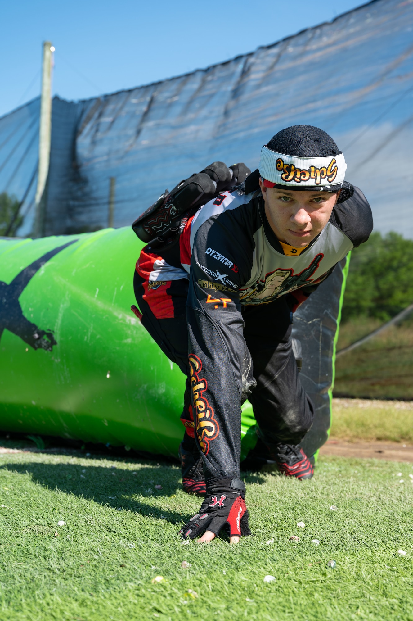 Airman 1st Class Caleb Porterfield, 736th Aircraft Maintenance C-17 Globemaster II crew chief, crouches in a starting position at a paintball field in Chesapeake City, Maryland, May 29, 2022. Porterfield competes on a Division 5 speedball team and plays the sport to stay physically active, connect with others and find his “inner peace.” (U.S. Air Force photo by Airman 1st Class Cydney Lee)