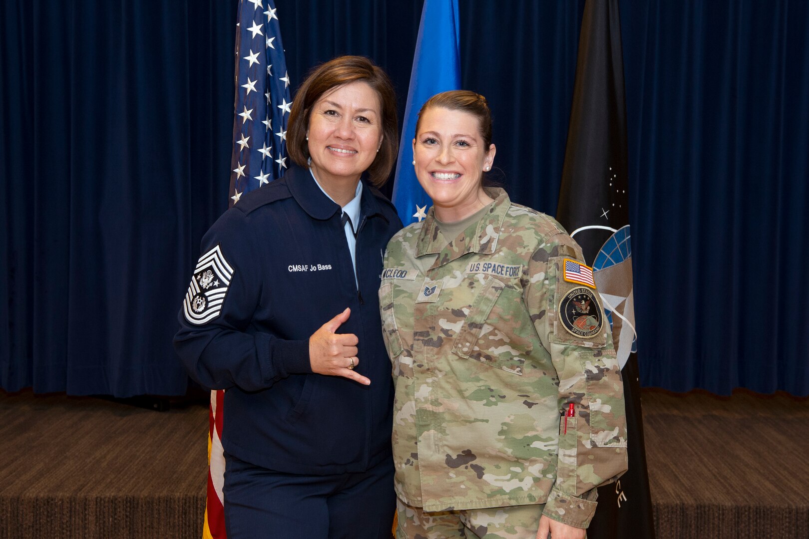 two military women in uniform standing and smiling