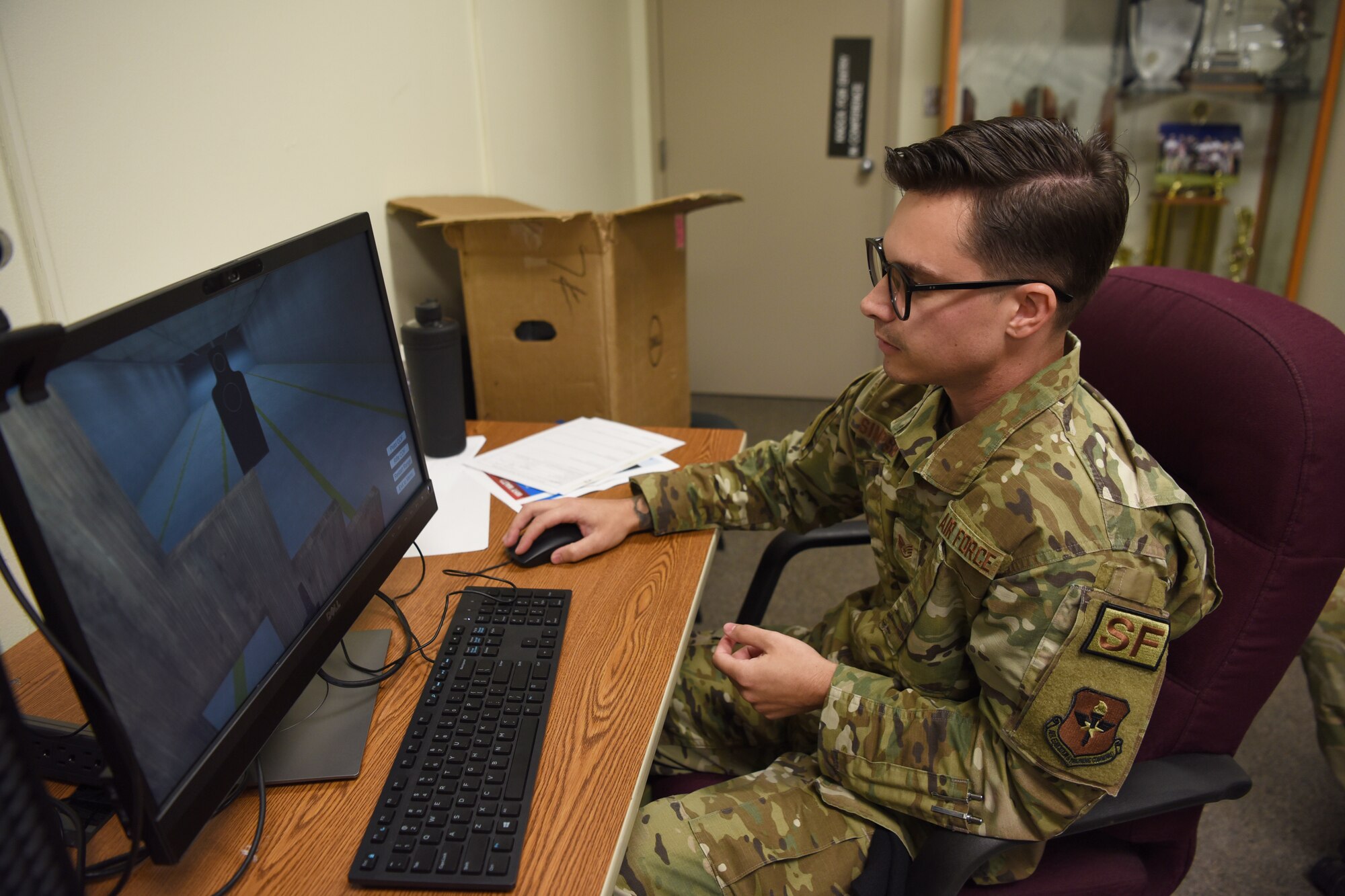 U.S. Air Force Staff Sgt. Mackenzie Simpson, 17th Security Forces Squadron trainer, operates a virtual reality simulator at Goodfellow Air Force Base, Texas, June 13, 2022. Simpson controlled safety scenarios for five U.S. Air Force Academy cadets who were developed in line with the 17th TRW’s mission to train, transform and empower future and coalition forces. (U.S. Air Force photo by Senior Airman Abbey Rieves)