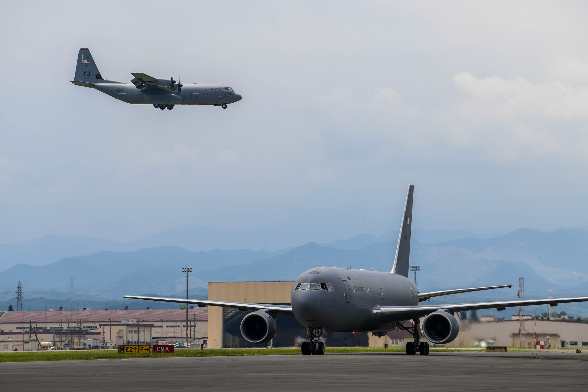 C-130J Super Hercules flies over a KC-46A Pegasus