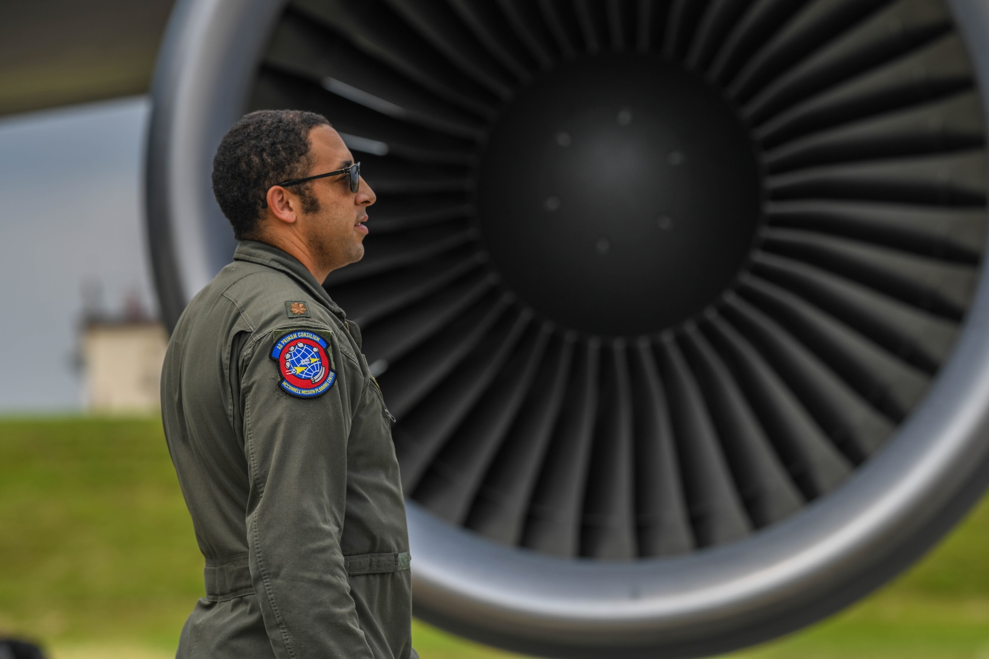 An Airman pauses in front of a KC-46A Pegasus engine