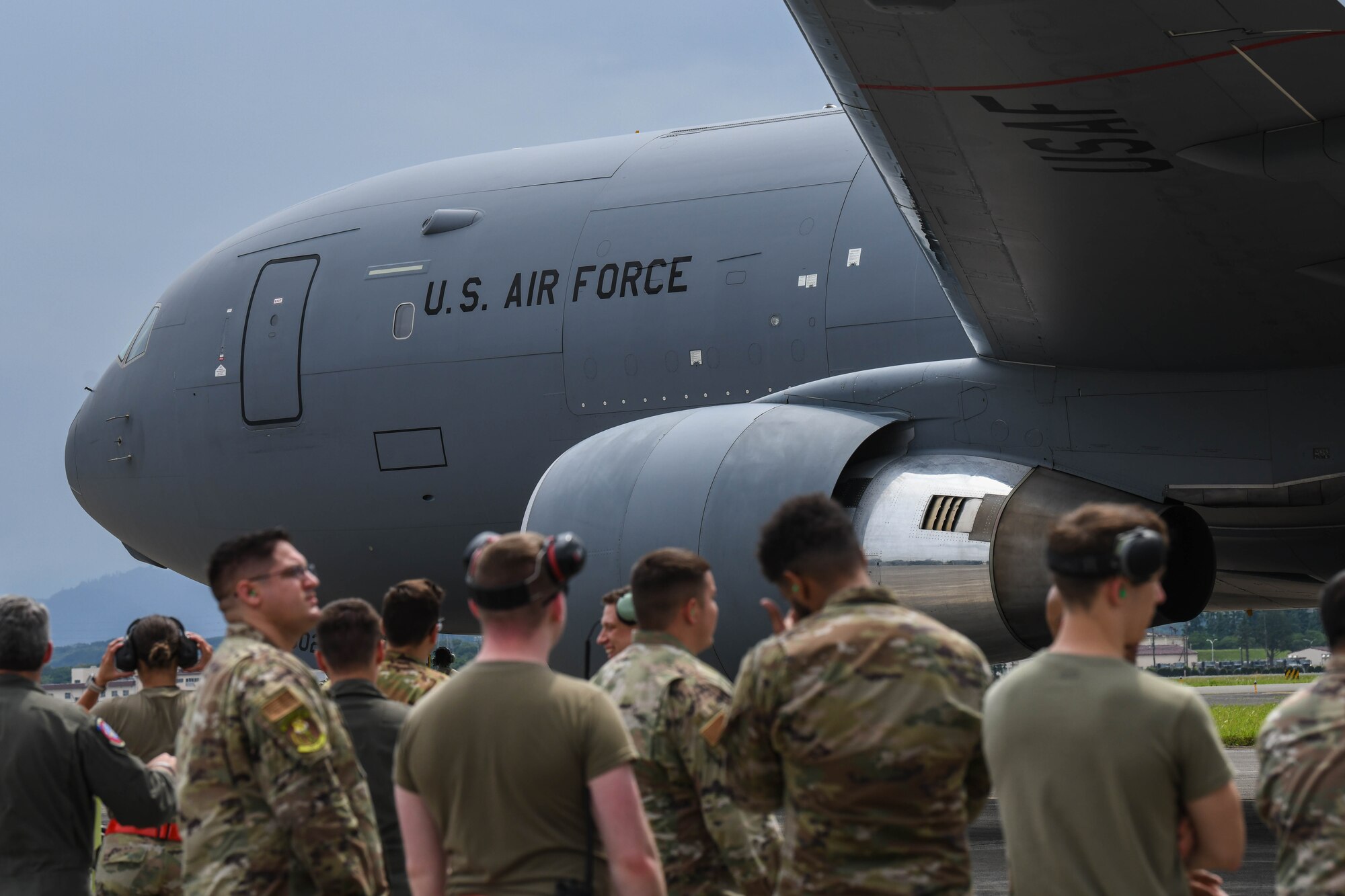 Airmen stand outside of a KC-46A Pegasus
