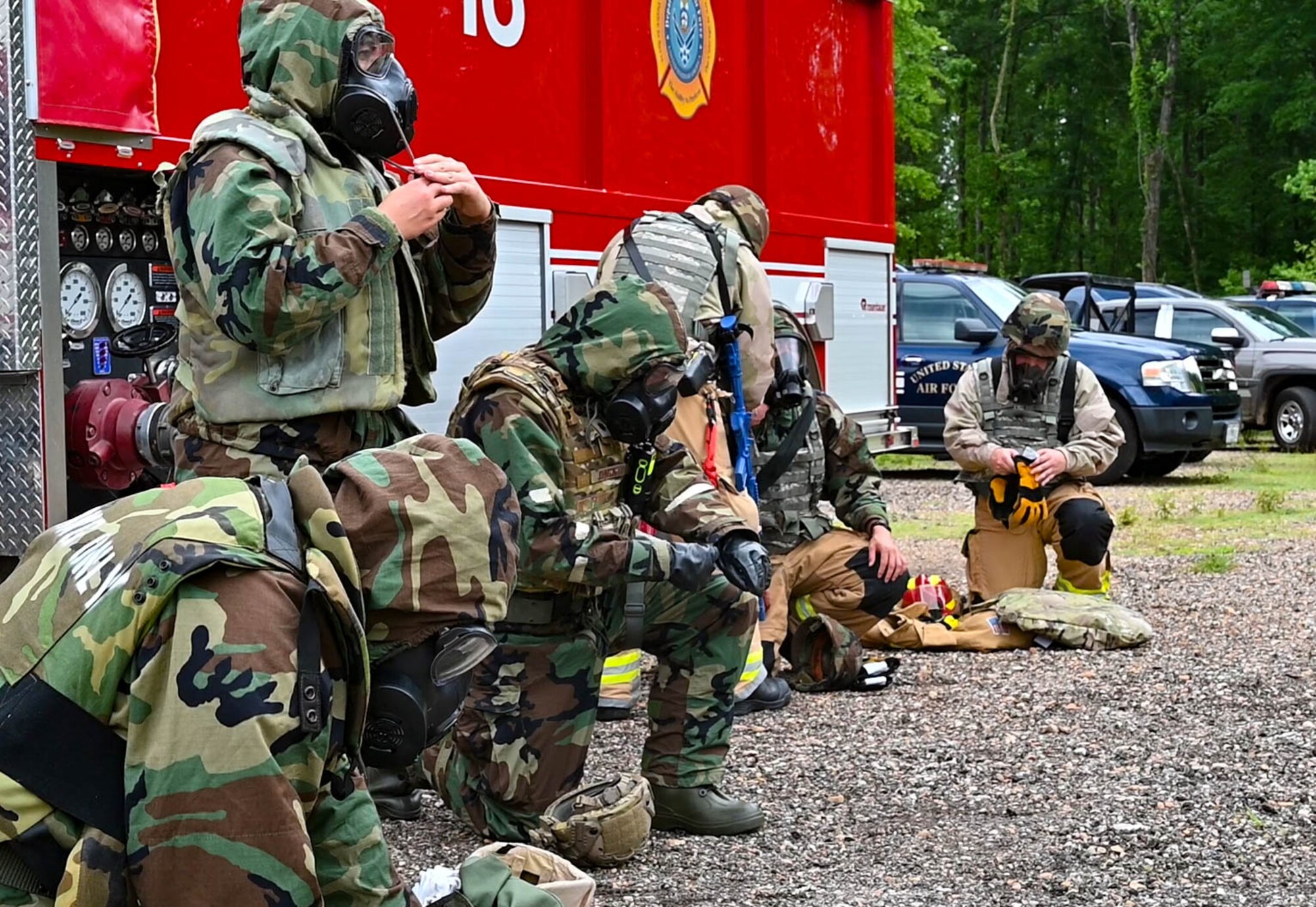 Members of the 14th Civil Engineer Squadron put on Chemical, Biological, Radiological and Nuclear (CBRN) gear during the CE 96-hour readiness exercise, May 24, 2022, on Columbus Air Force Base, Miss. The CBRN training was conducted in the BLAZE arena, which was built by the 14th CES to hold gas mask confidence training. (U.S. Air Force photo by Staff Sgt. Jake Jacobsen)