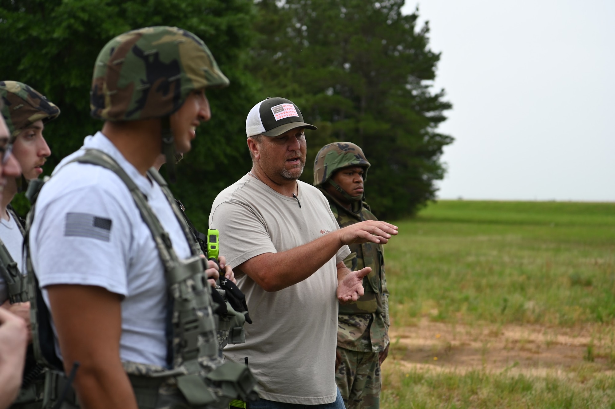 James Dyer (center), 14th Civil Engineer Squadron heavy equipment operator, teaches his military counterparts about the machinery they are about to work with, May 24, 2022, on Columbus Air Force base Miss. The exercise served as an opportunity to further enhance the squadron's expeditionary skills and build more competent Multi-Capable Airmen. (U.S. Air Force photo by 2nd Lt. Peyton Craven)