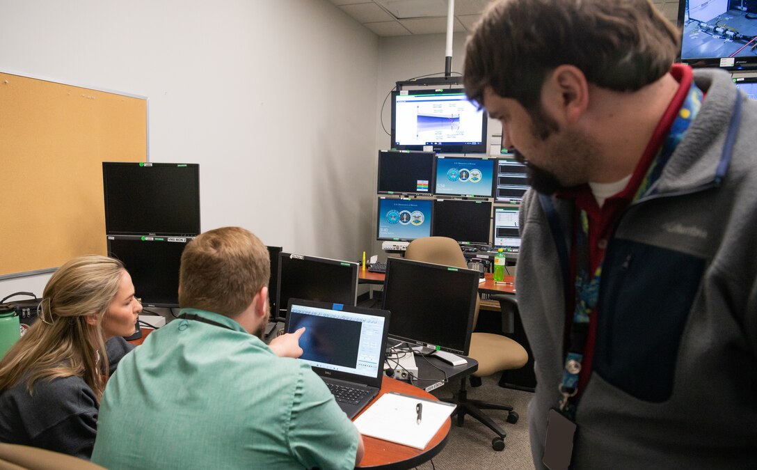 From left, Haley Goldston, a research assistant with the University of Tennessee Space Institute (UTSI); Dr. Phil Kreth, an assistant professor with UTSI; and Justin Thomas, a test engineer with the 717th Test Squadron, 804th Test Group, Arnold Engineering Development Complex, look at shadowgraph data during an experiment in SL-2.