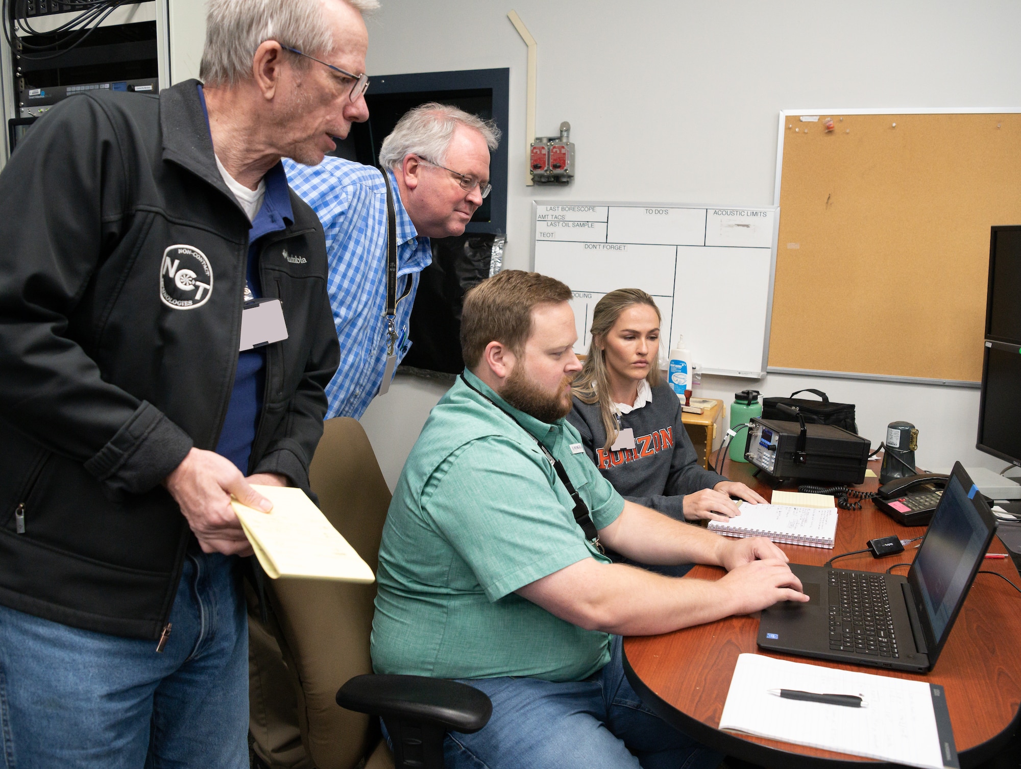 From left, Terry Hayes, vice president and chief technical officer of Non-Contact Technologies, LLC; Steve Arnold, technical adviser for the 717th Test Squadron, 804th Test Group, Arnold Engineering Development Complex; Dr. Phil Kreth, an assistant professor with the University of Tennessee Space Institute (UTSI); and Haley Goldston, a research assistant with UTSI, look at shadowgraph data during an experiment in SL-2.