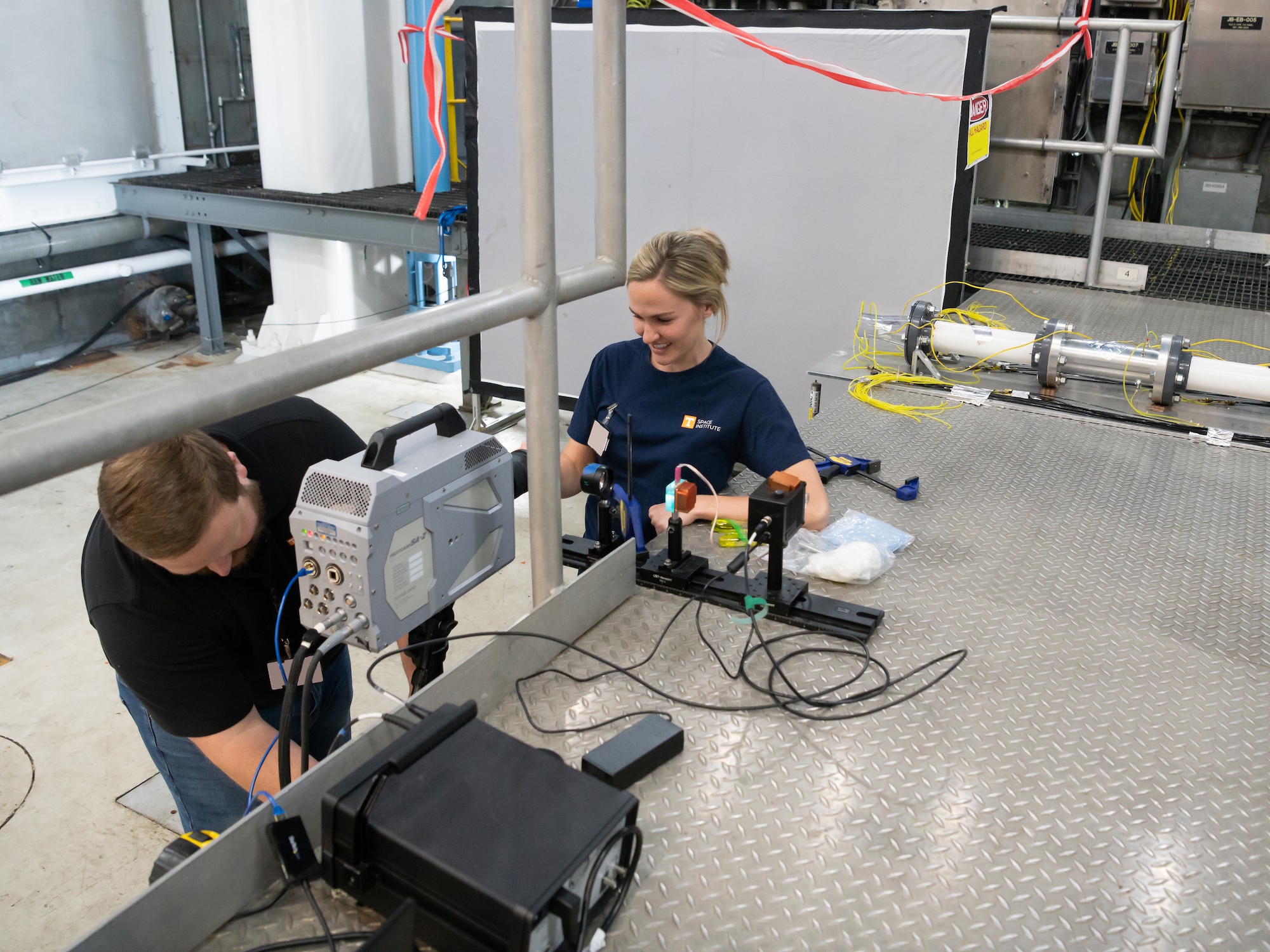 Dr. Phil Kreth and Haley Goldston, with the University of Tennessee Space Institute, set up equipment in SL-2, a sea level turbine engine test cell at Arnold Air Force Base, Tenn.